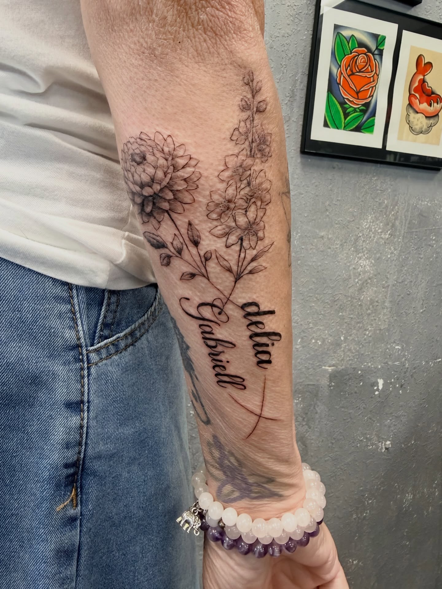 Floral arrangement black and grey tattoo on the forearm by Chris