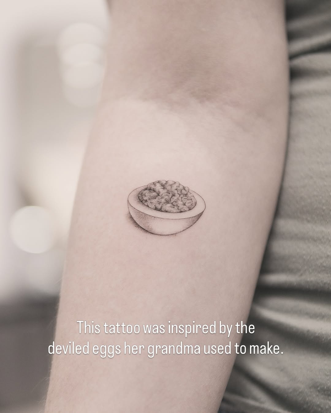 Deviled egg minimalist tattoo on the forearm by Joey