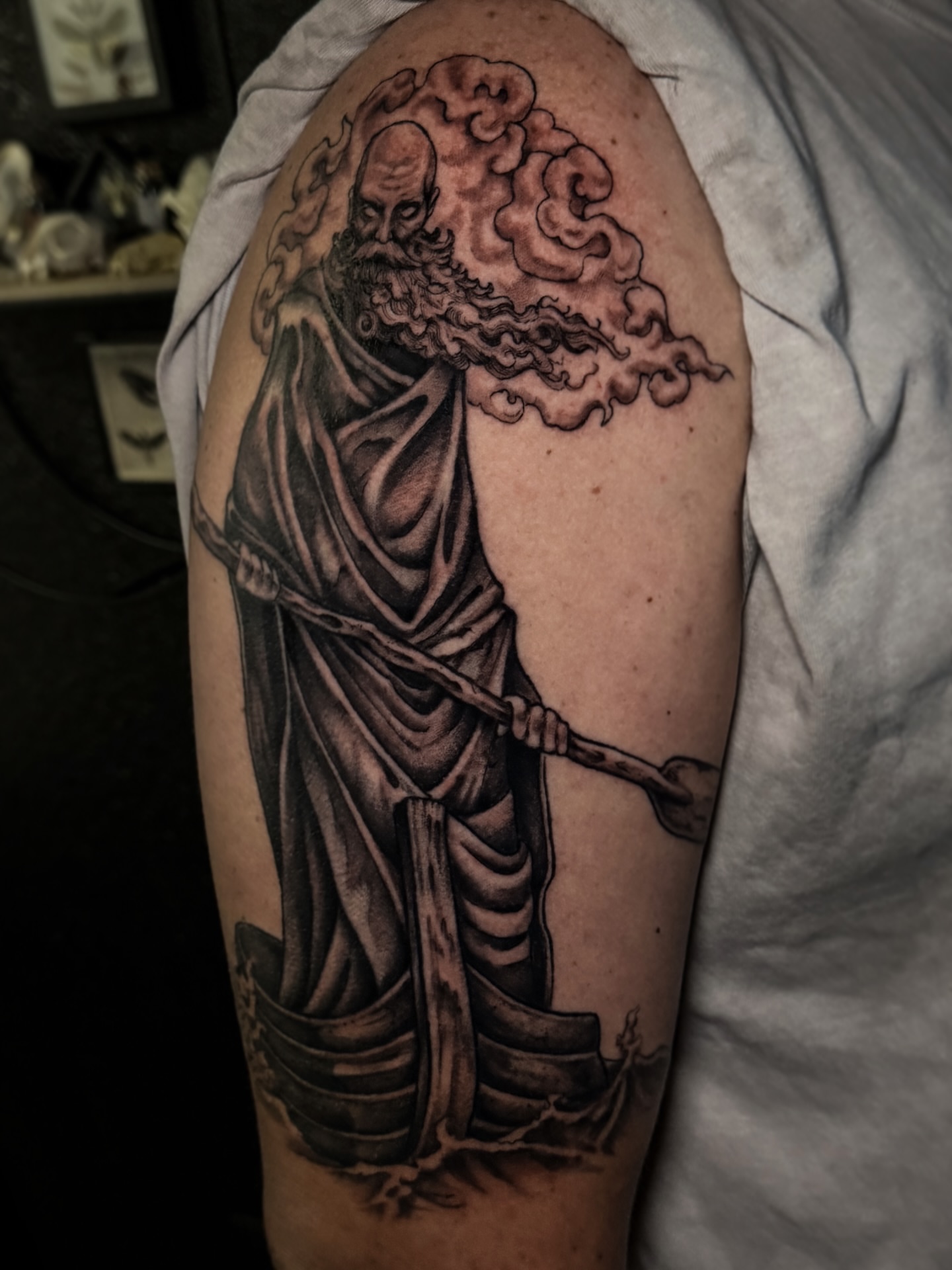 Bearded figure realism tattoo on the upper arm by Cristen Aro