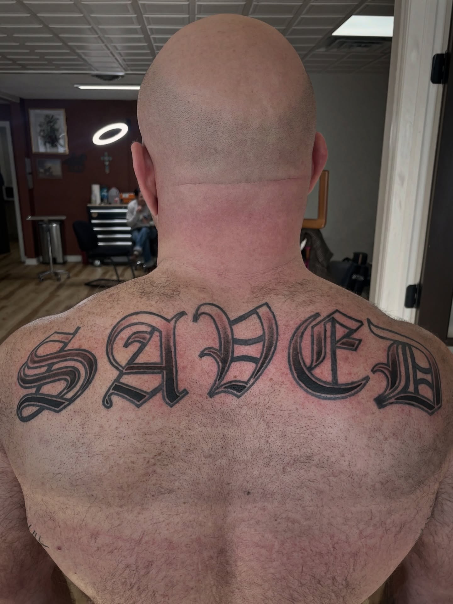 Saved lettering script tattoo on the back by Francesca Siwa