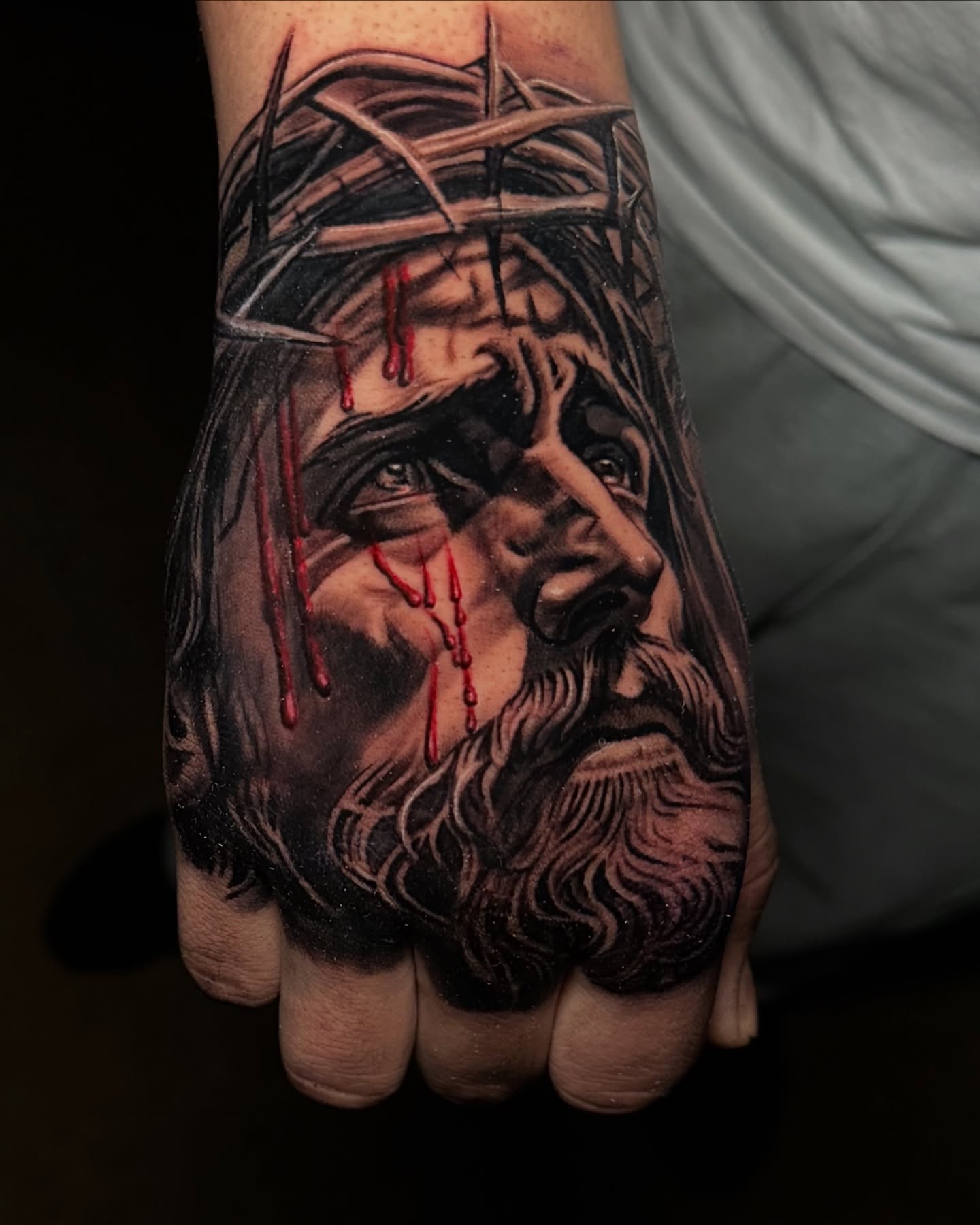 Jesus Christ realism tattoo on the hand by Christian Medina, Sacramento, California