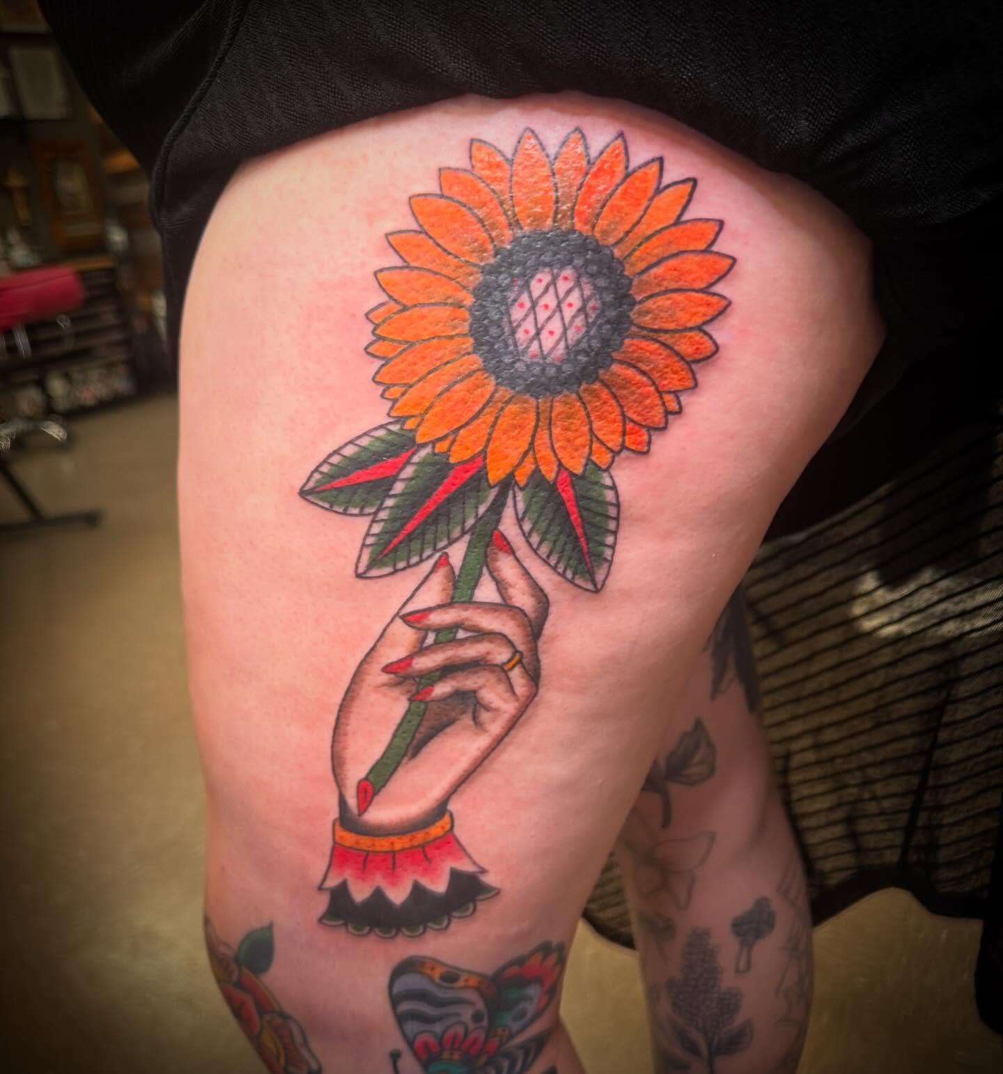 Sunflower American traditional tattoo on the thigh by ArJay Smith