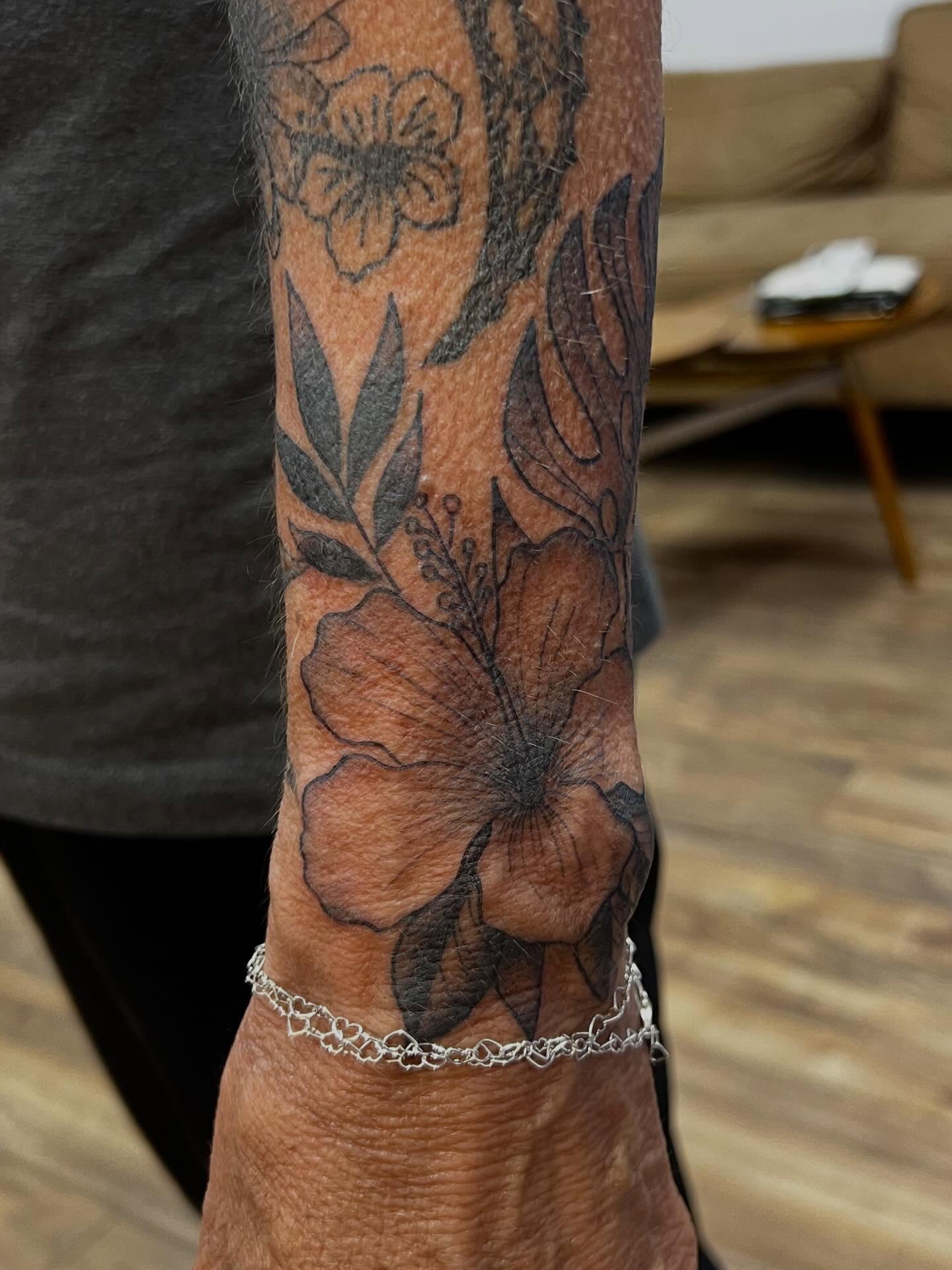 Flower black and grey tattoo on the forearm by Victorian Coleman