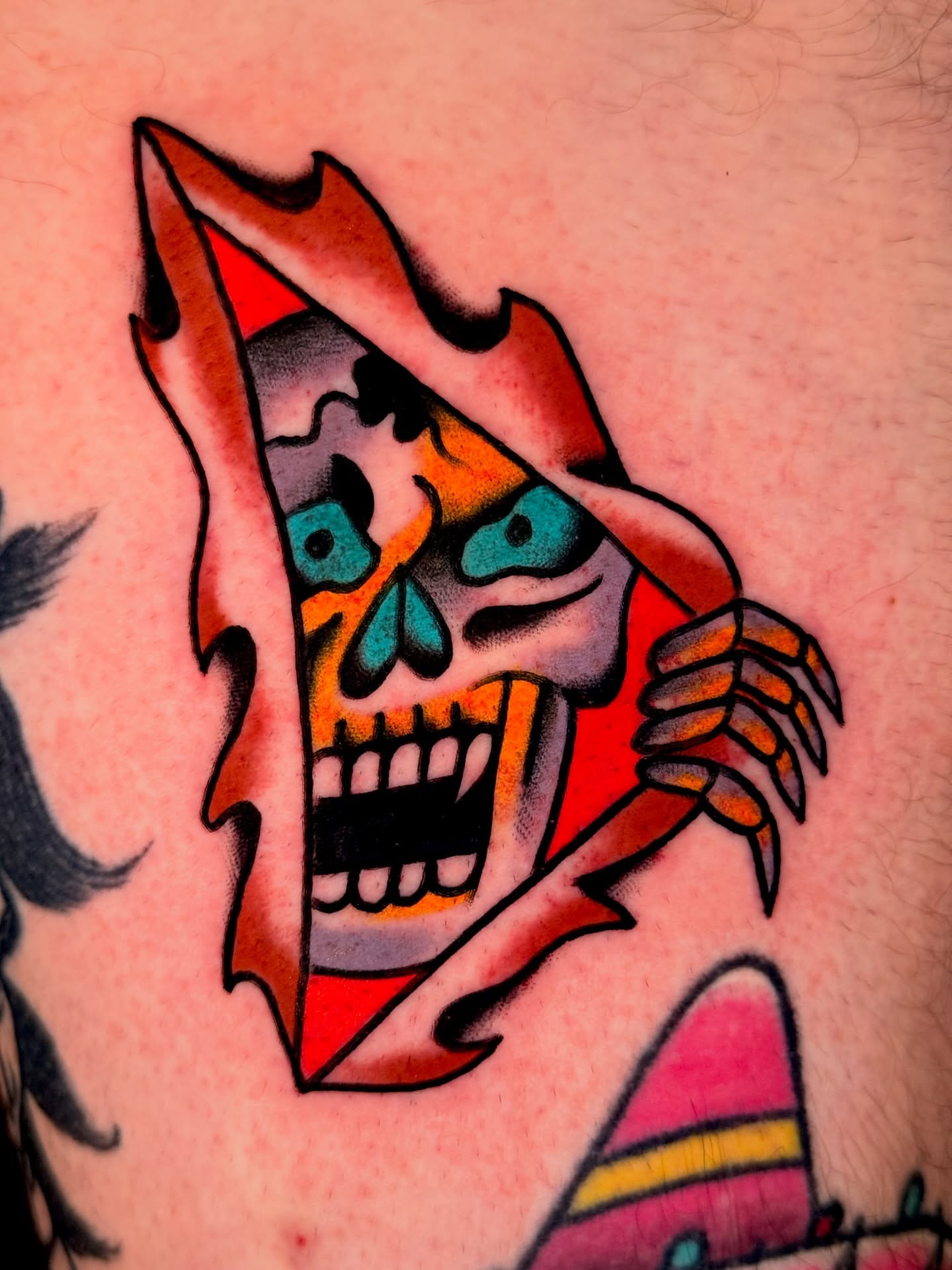 Skull American traditional tattoo on the upper arm by {{Theo Glanton}}