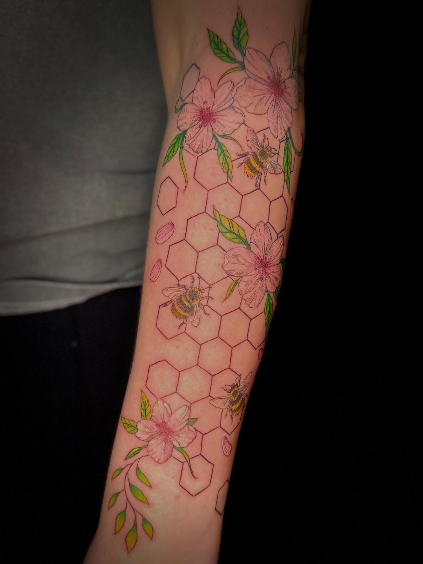 Cherry blossoms and bees geometric tattoo on the forearm by Olivia, Royal Oak, Michigan