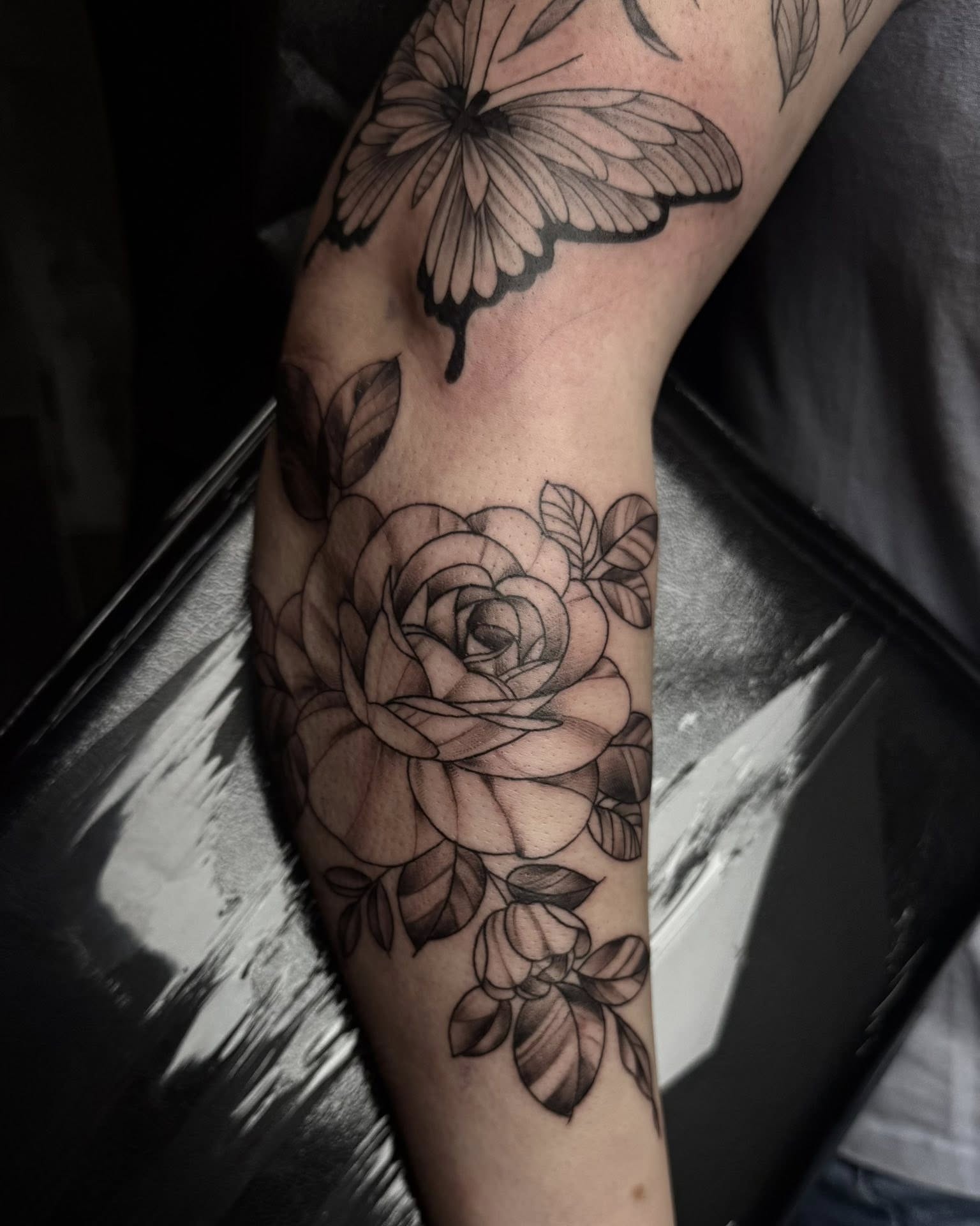 Rose and butterfly realism tattoo on the forearm by Madison Jasso