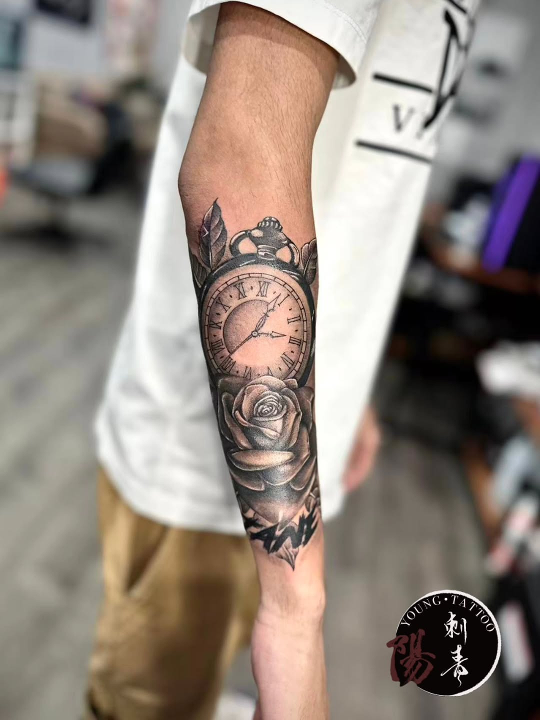 Clock and rose realism tattoo on the forearm by Ying