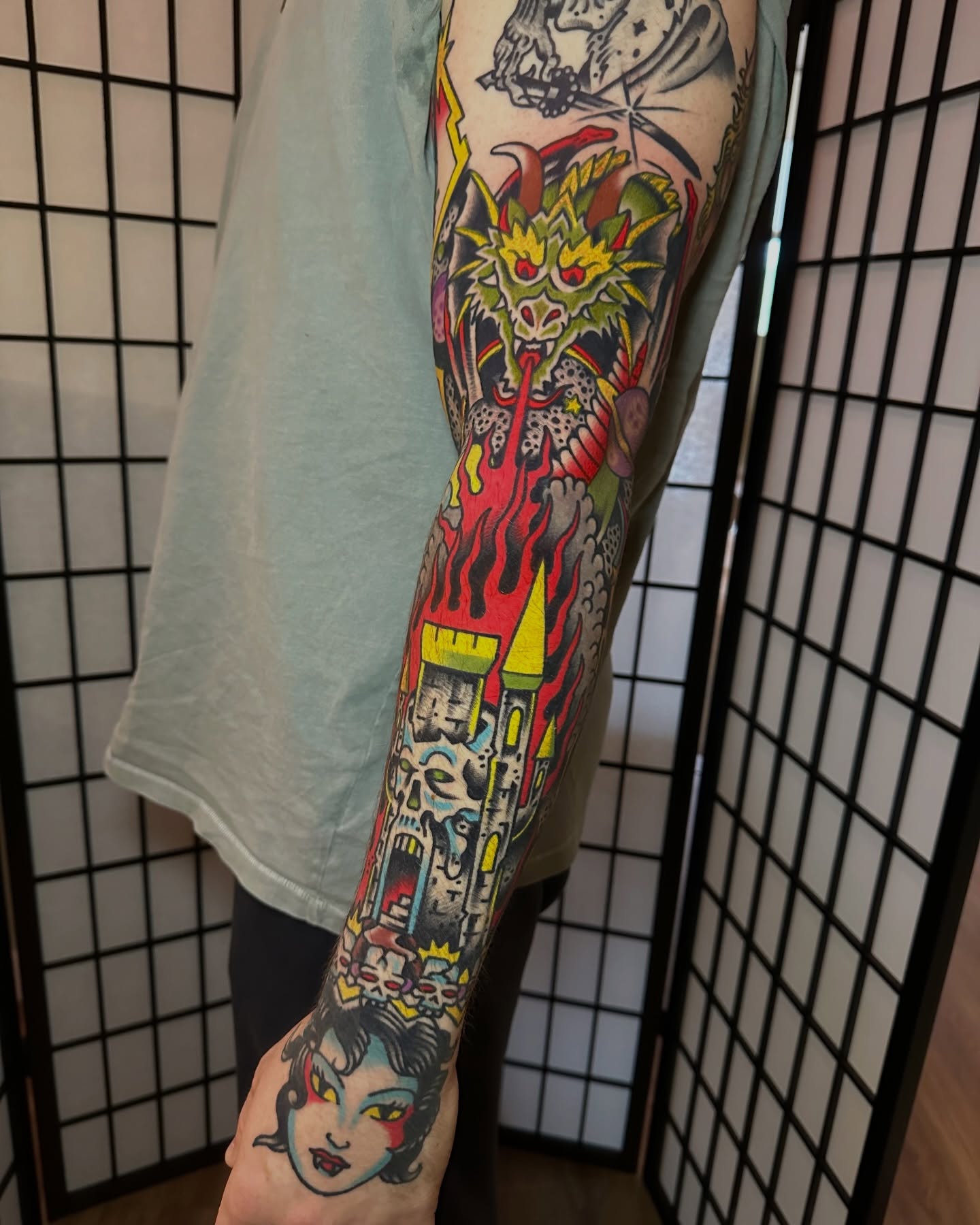 Monster and fire American traditional tattoo on the forearm by Christian Rieben