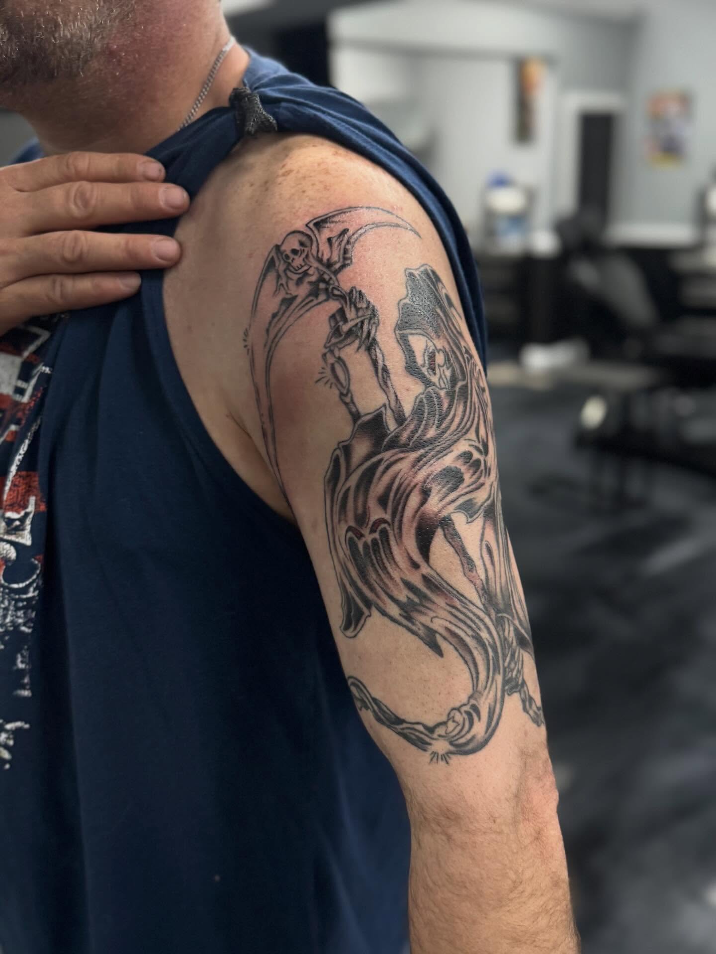 Skeleton riding horse black and grey tattoo on the upper arm by Marie Amor🌙