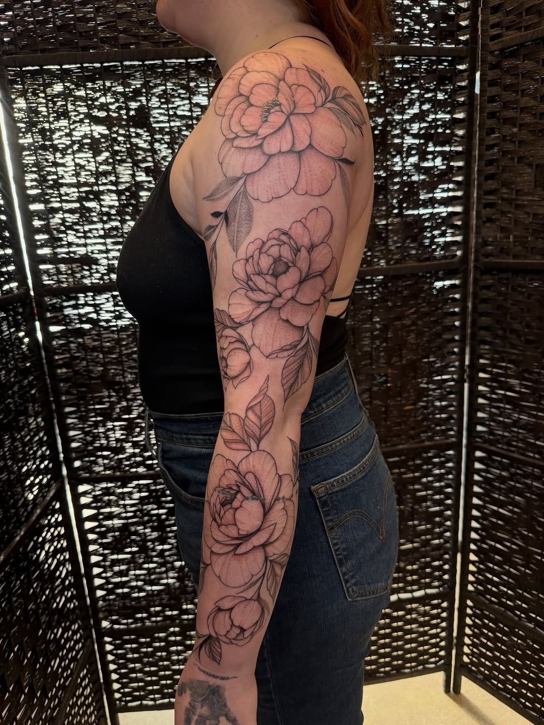 Peony flowers and leaves fine line tattoo on the upper arm by WhoisLaineyTattoos