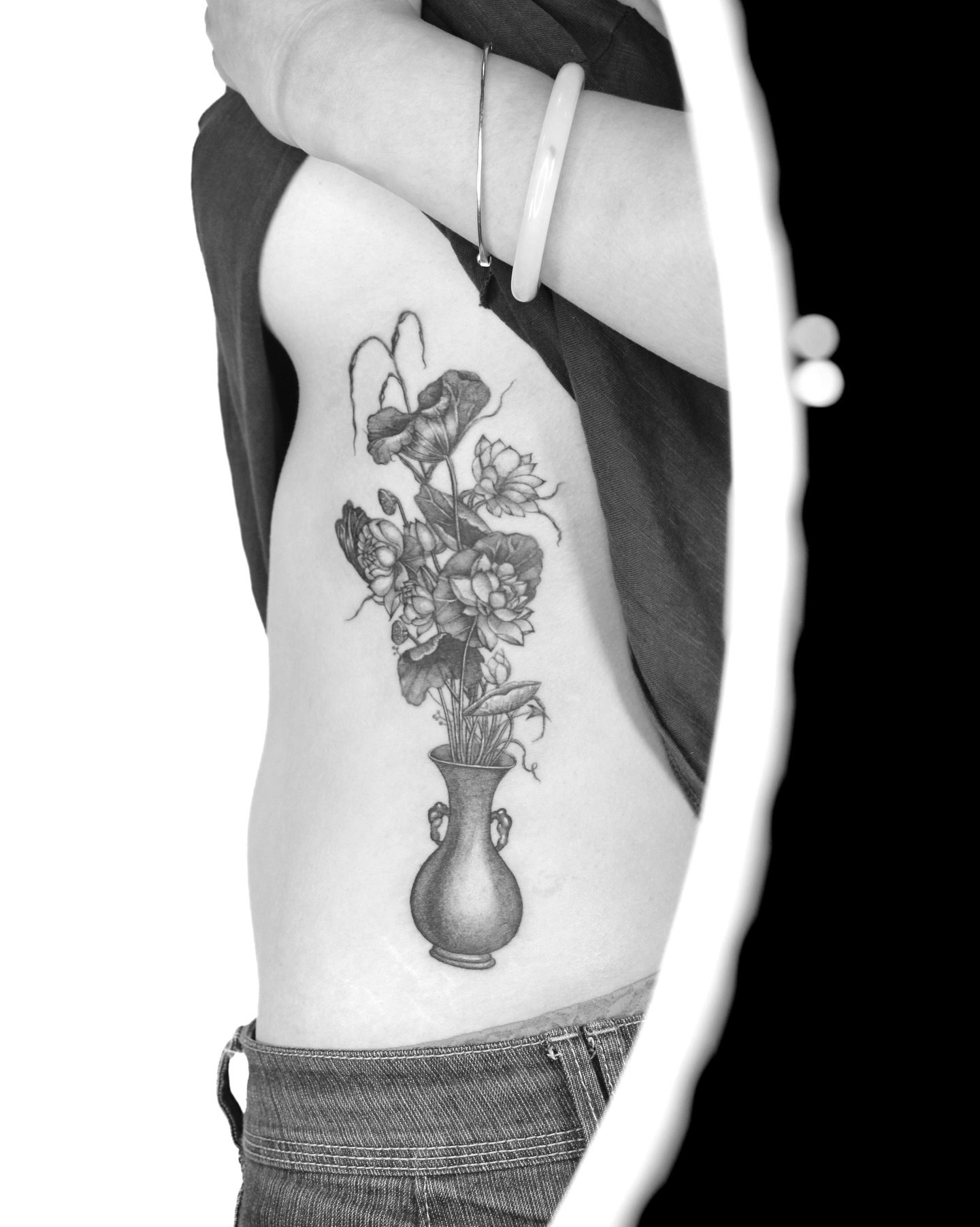 Flower arrangement realism tattoo on the ribs by Tatmostat