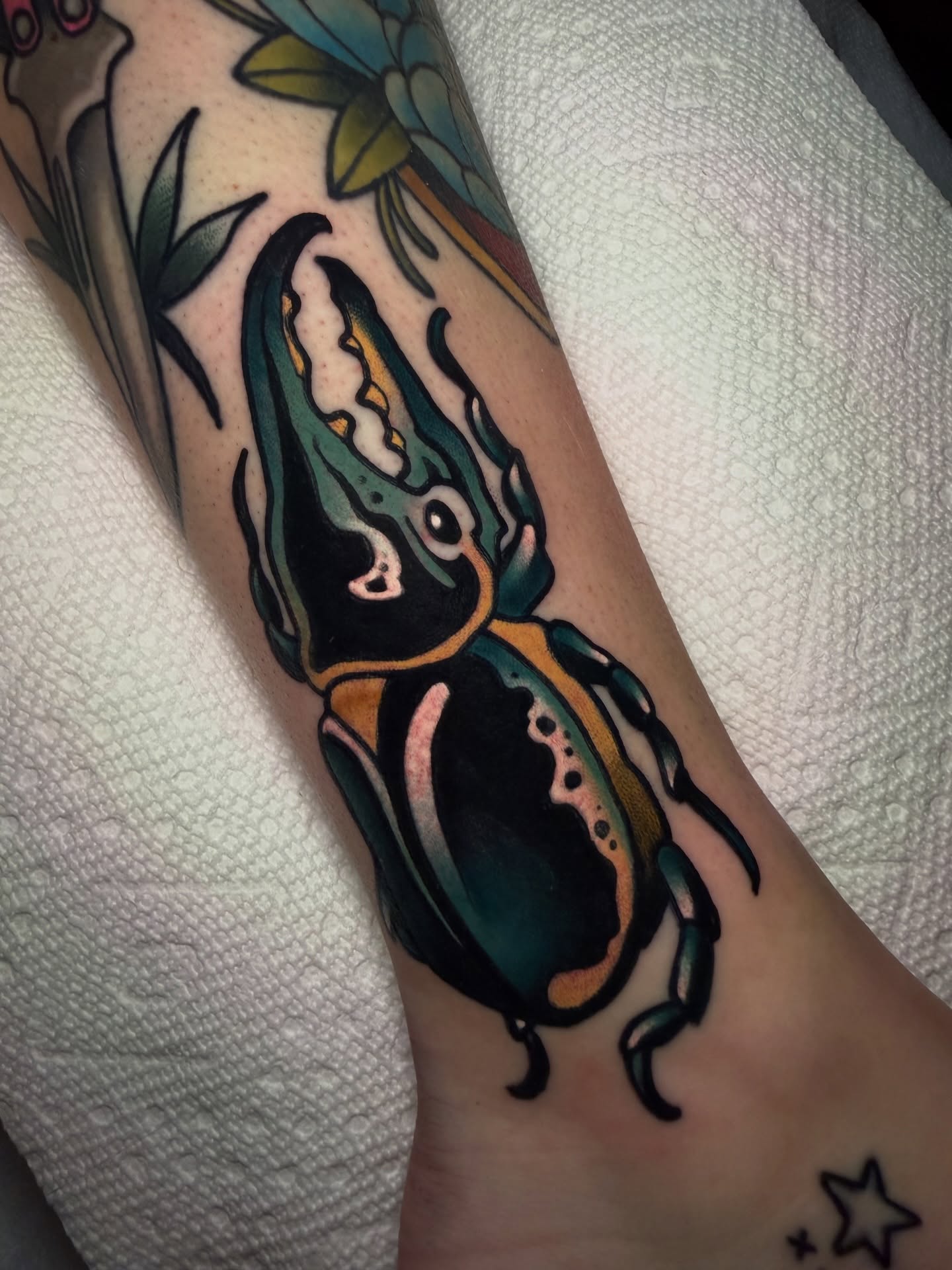 Beetle American traditional tattoo on the forearm by Cory Cartwright