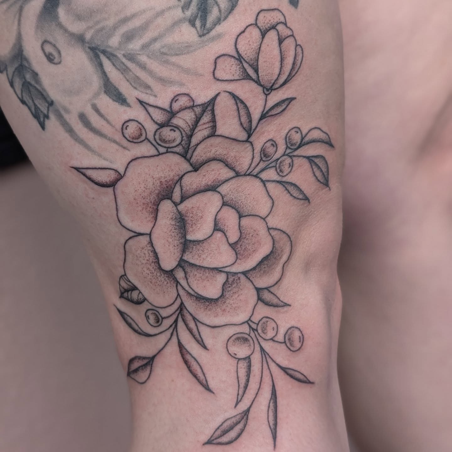 Flower bouquet dotwork tattoo on the thigh by Alexandria Green