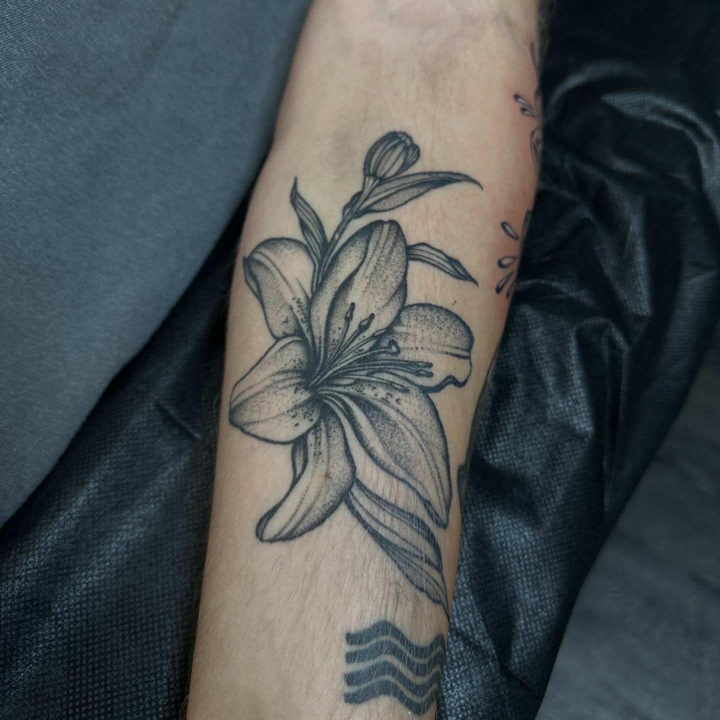 Lily dotwork tattoo on the forearm by Ciera Farni, Murray, Utah