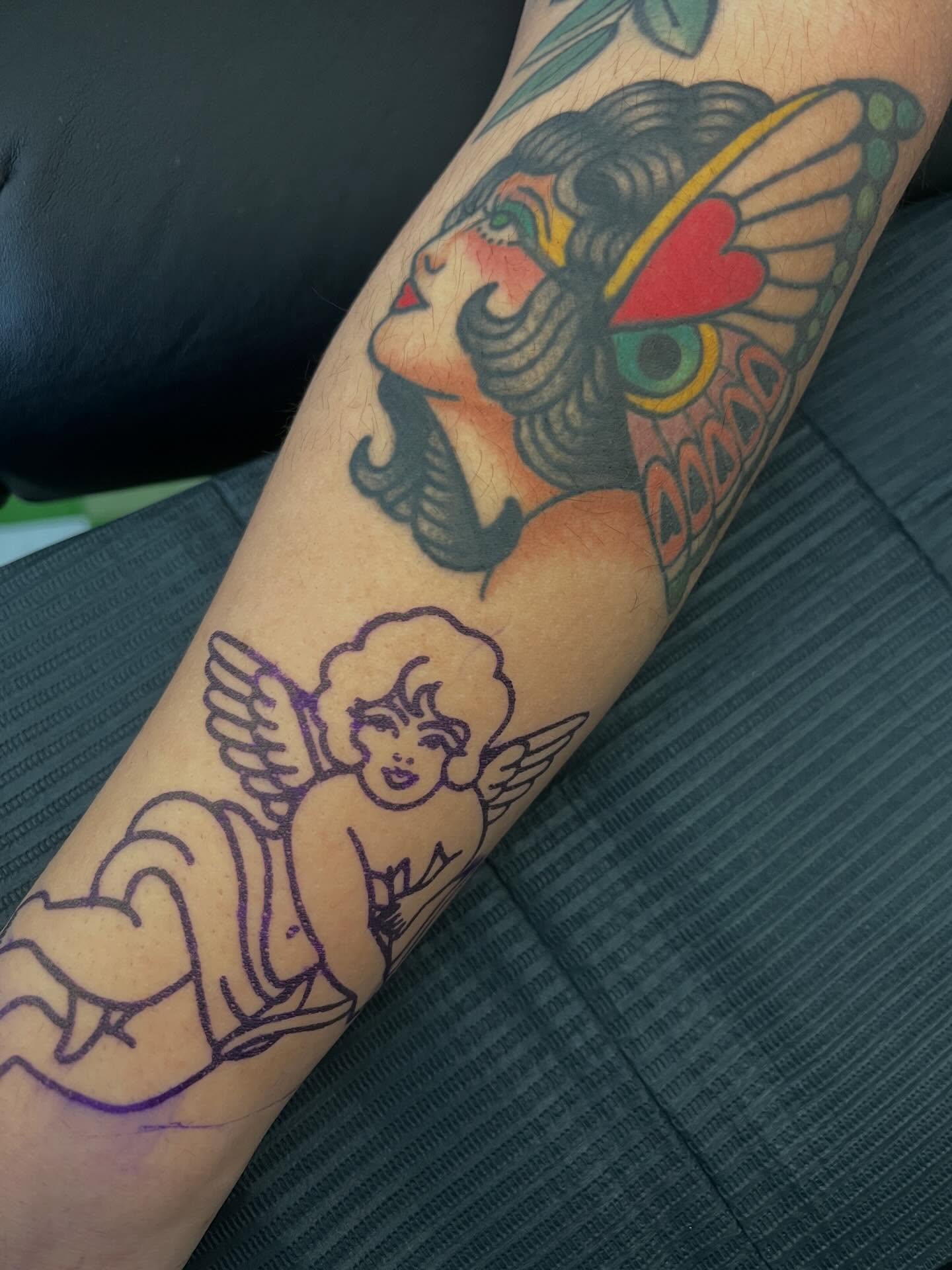 Angel and lion American traditional tattoo on the forearm by ⭐️ Erin Bauer ⭐️