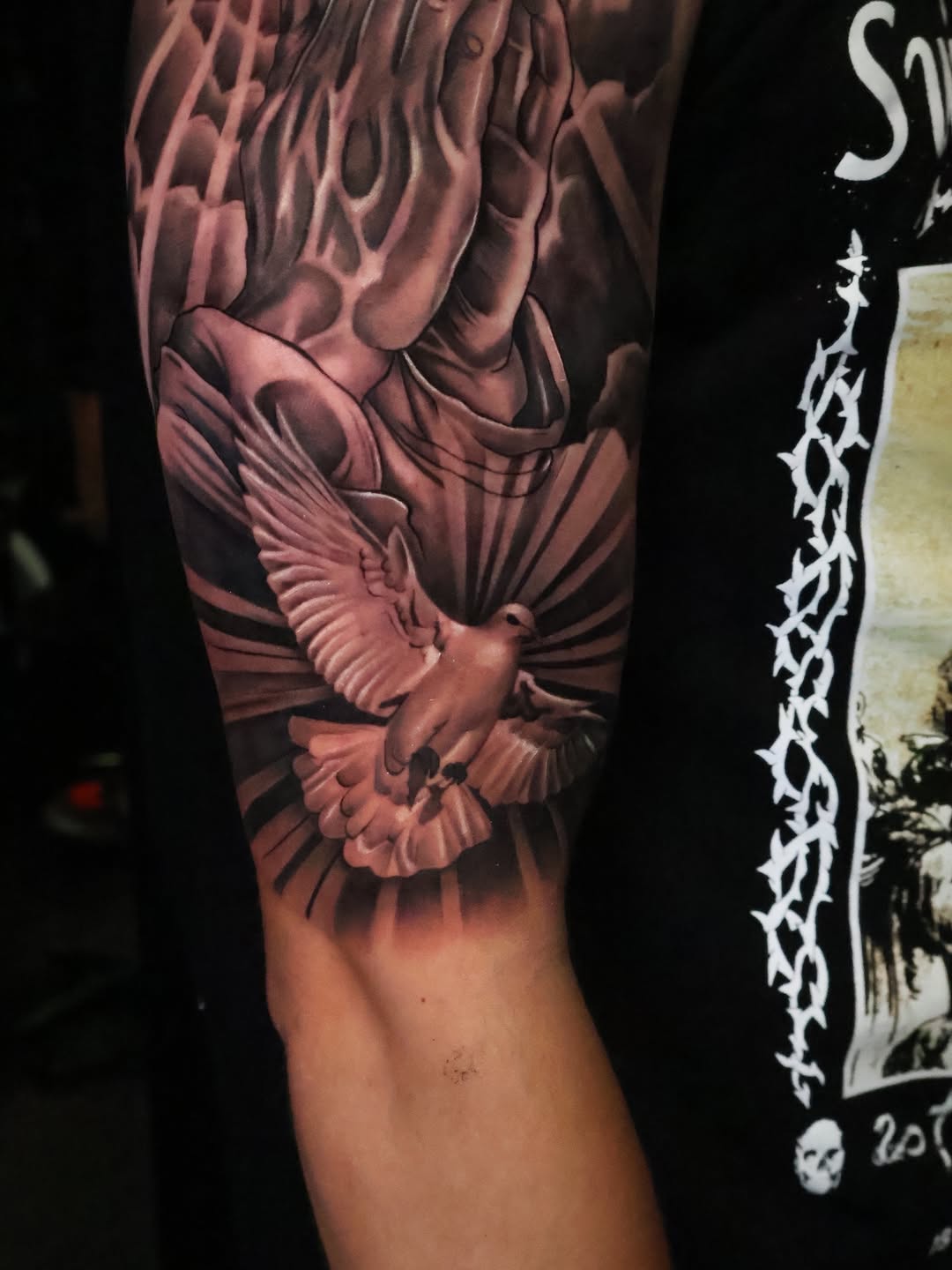 Praying hands and dove realism tattoo on the forearm by Angels tattoo