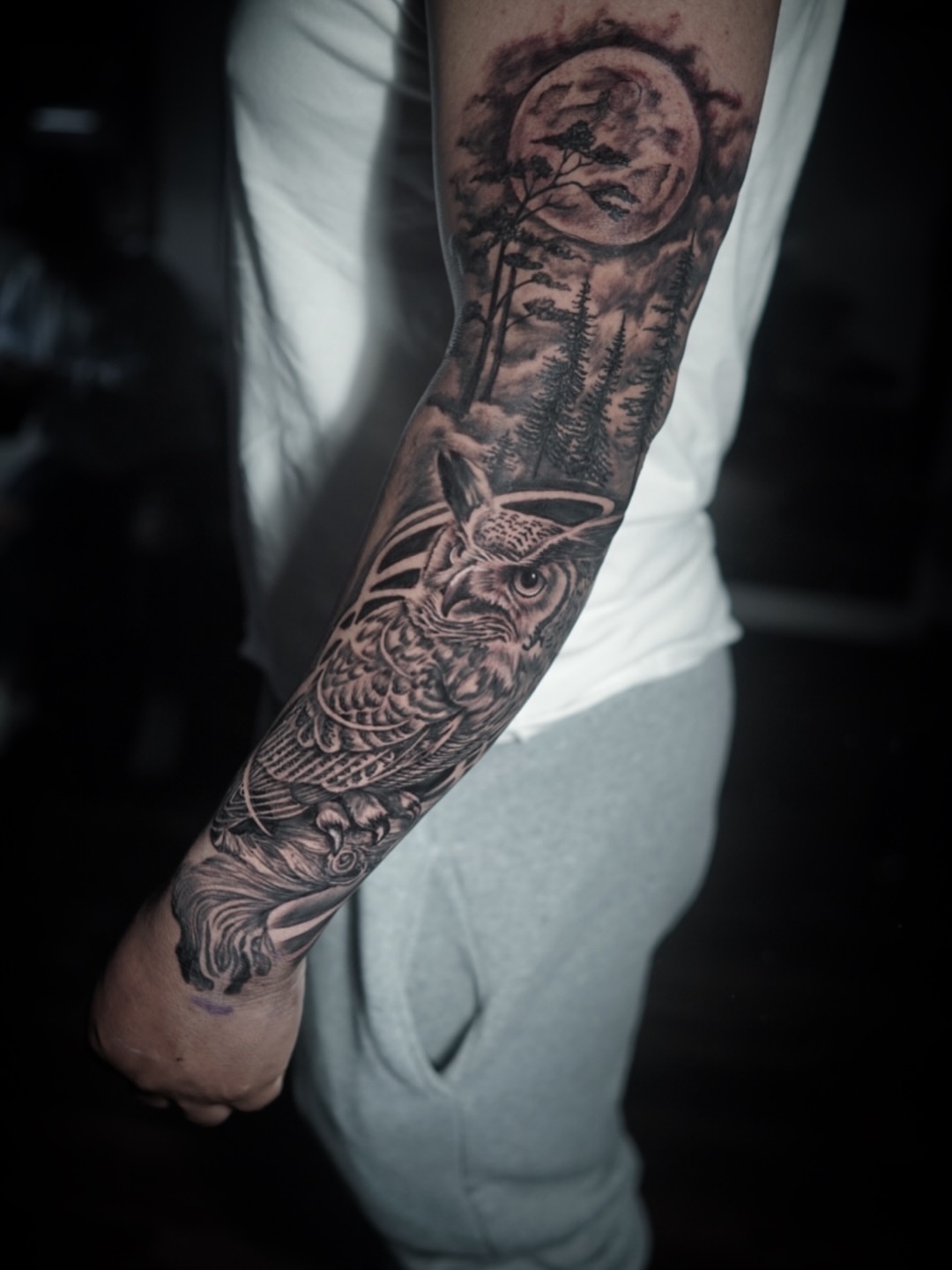 Owl and forest realism tattoo on the forearm by Niko Hosk Cataldo
