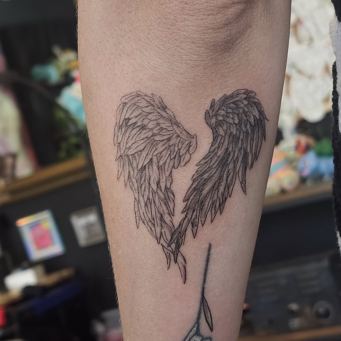 Broken wings black and grey tattoo on the forearm by Casey Jo