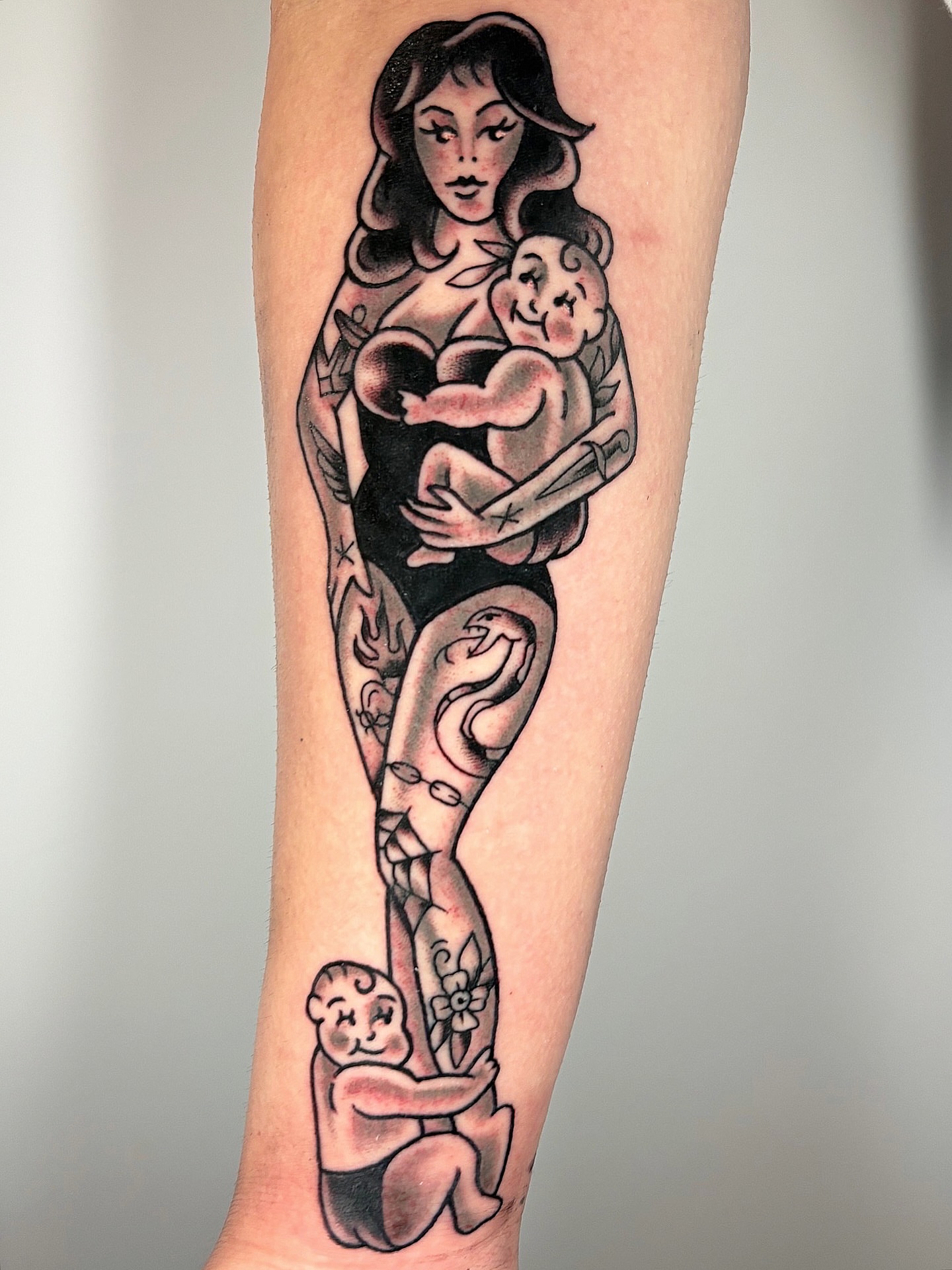Mother and child American traditional tattoo on the forearm by ๐ต๐๐๐๐ ๐ฎ๐๐๐๐๐๐, New Orleans, Louisiana