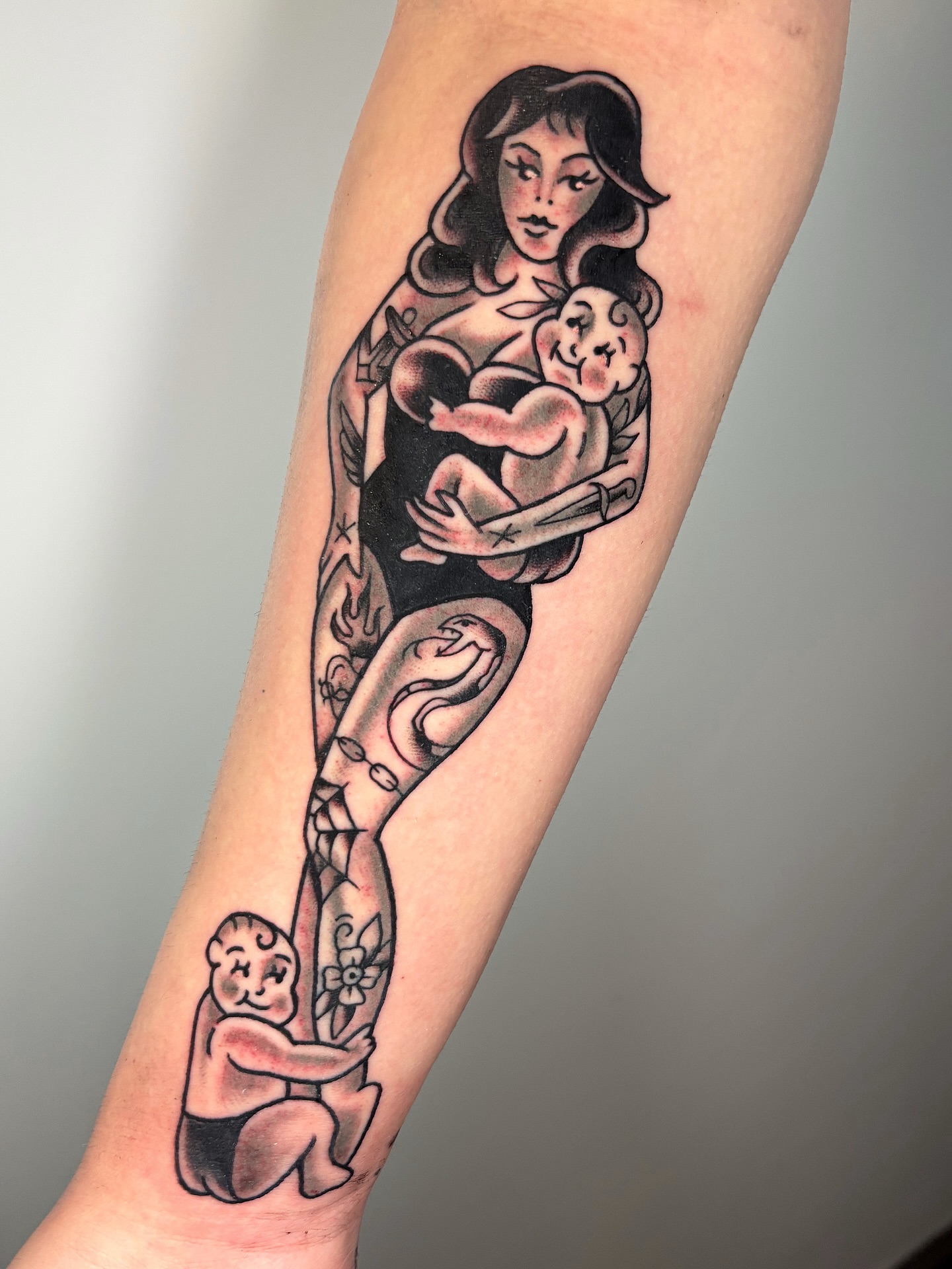 Mother and child American traditional tattoo on the forearm by ๐ต๐๐๐๐ ๐ฎ๐๐๐๐๐๐, New Orleans, Louisiana