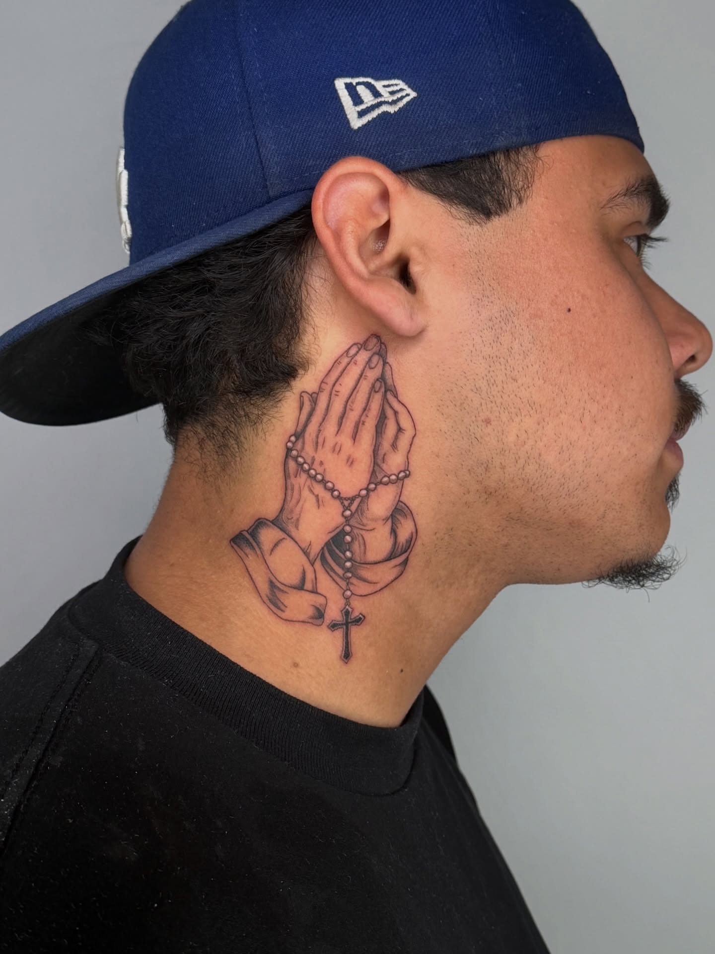 Praying hands with rosary realism tattoo on the neck by Jerm Lewis
