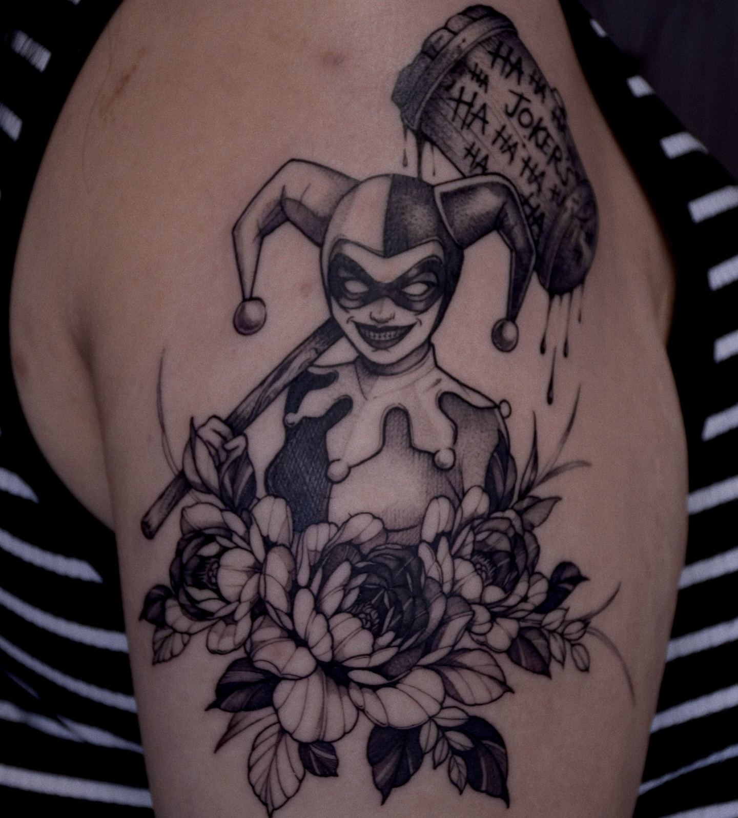 Joker character with flowers realism tattoo on the upper arm by Gary Zhong, Upland, California
