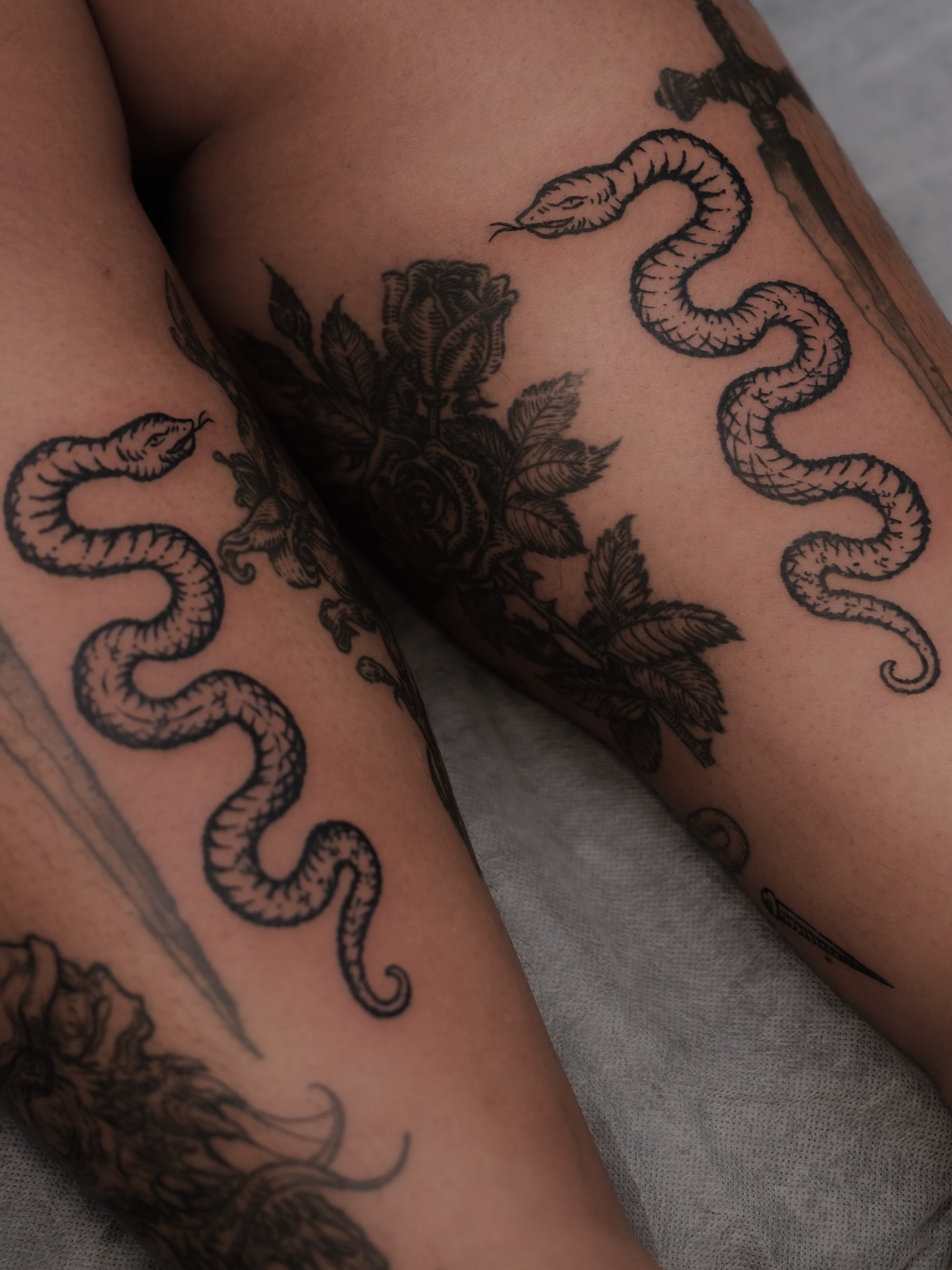Snake and roses black and grey tattoo on the forearm by ꜰʟᴏʀᴀ ᴡᴏᴏᴅᴄᴜᴛ ᴛᴀᴛᴛᴏᴏ