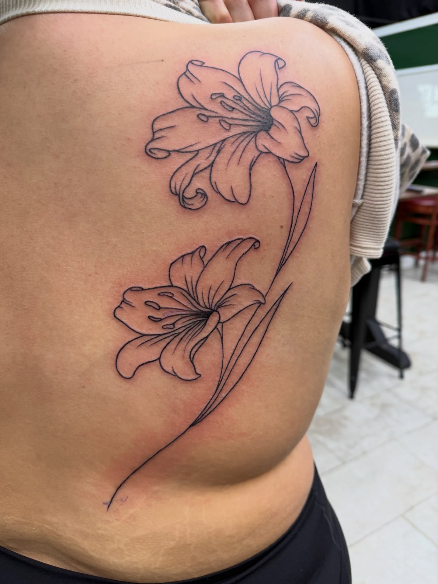 Lilies black and grey tattoo on the ribs by Squid