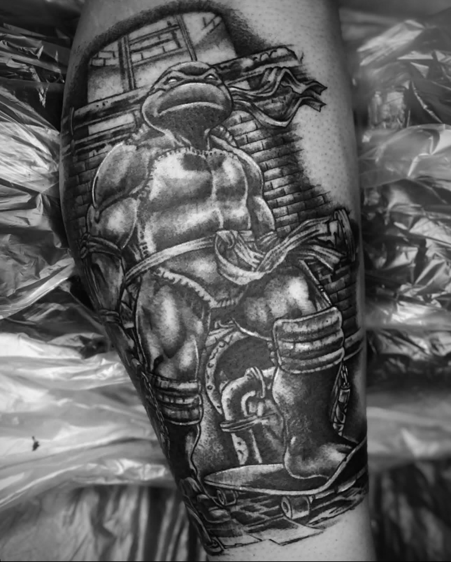 Teenage mutant ninja turtle black and grey tattoo on the forearm by Big Steve Lewis