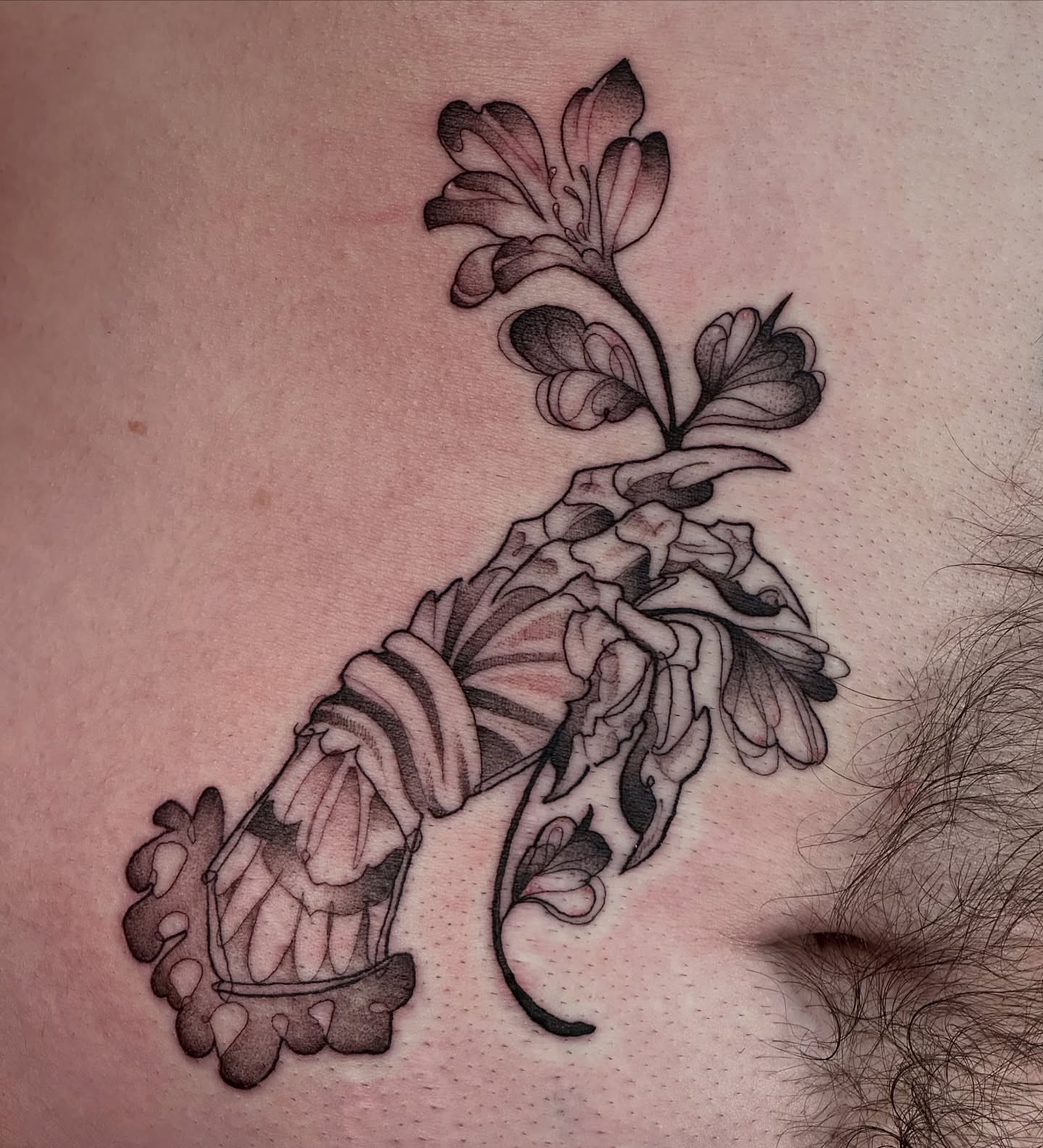 Flower and abstract form black and grey tattoo on the torso by TATTOOLIZARD (James)