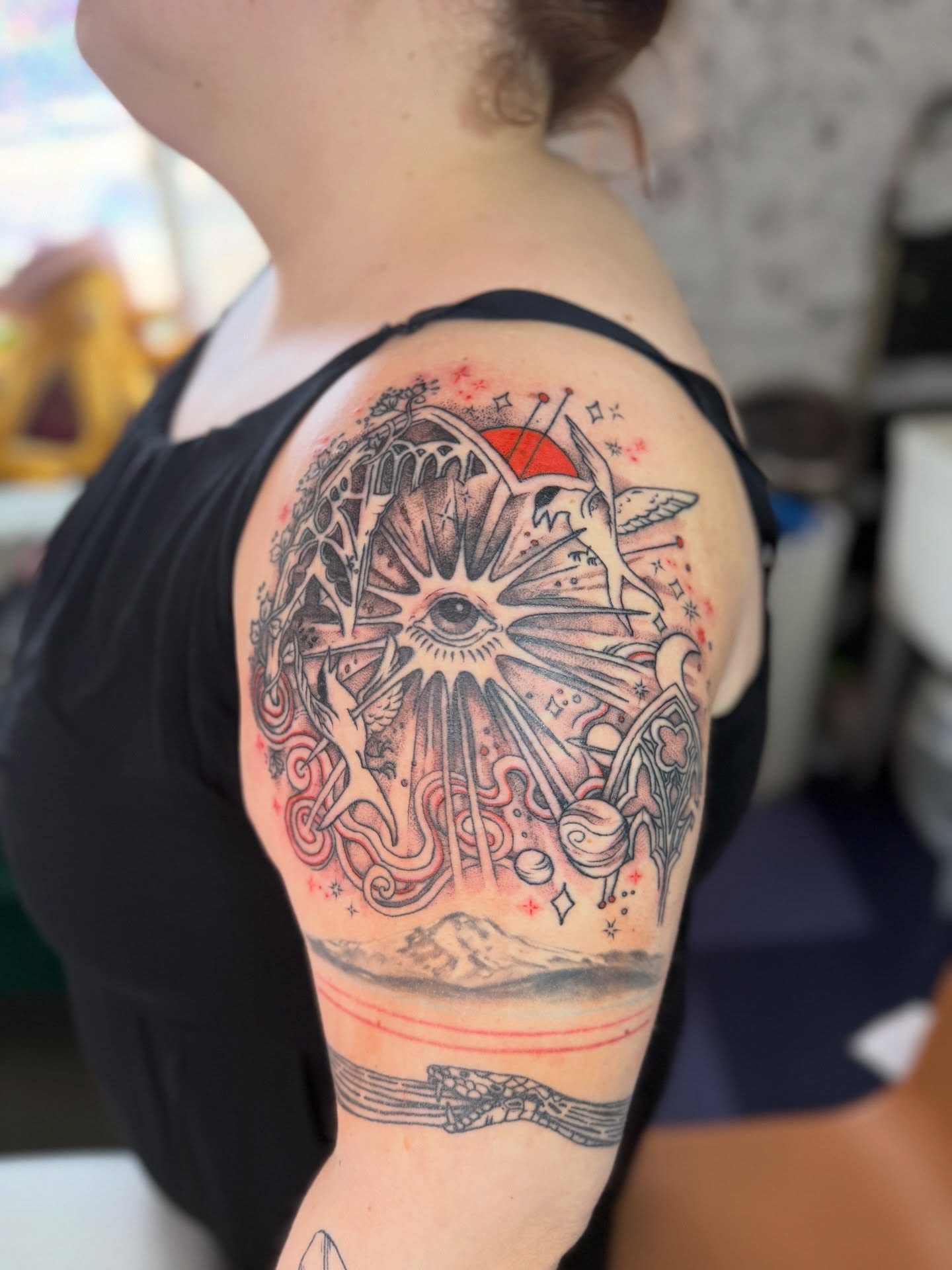 Eye and celestial symbols neo-traditional tattoo on the shoulder by Emma Berger