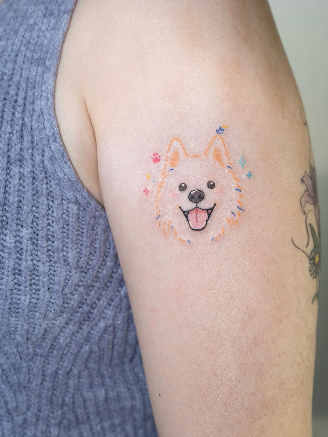 Dog face with sparkles new school tattoo on the upper arm by Tomato