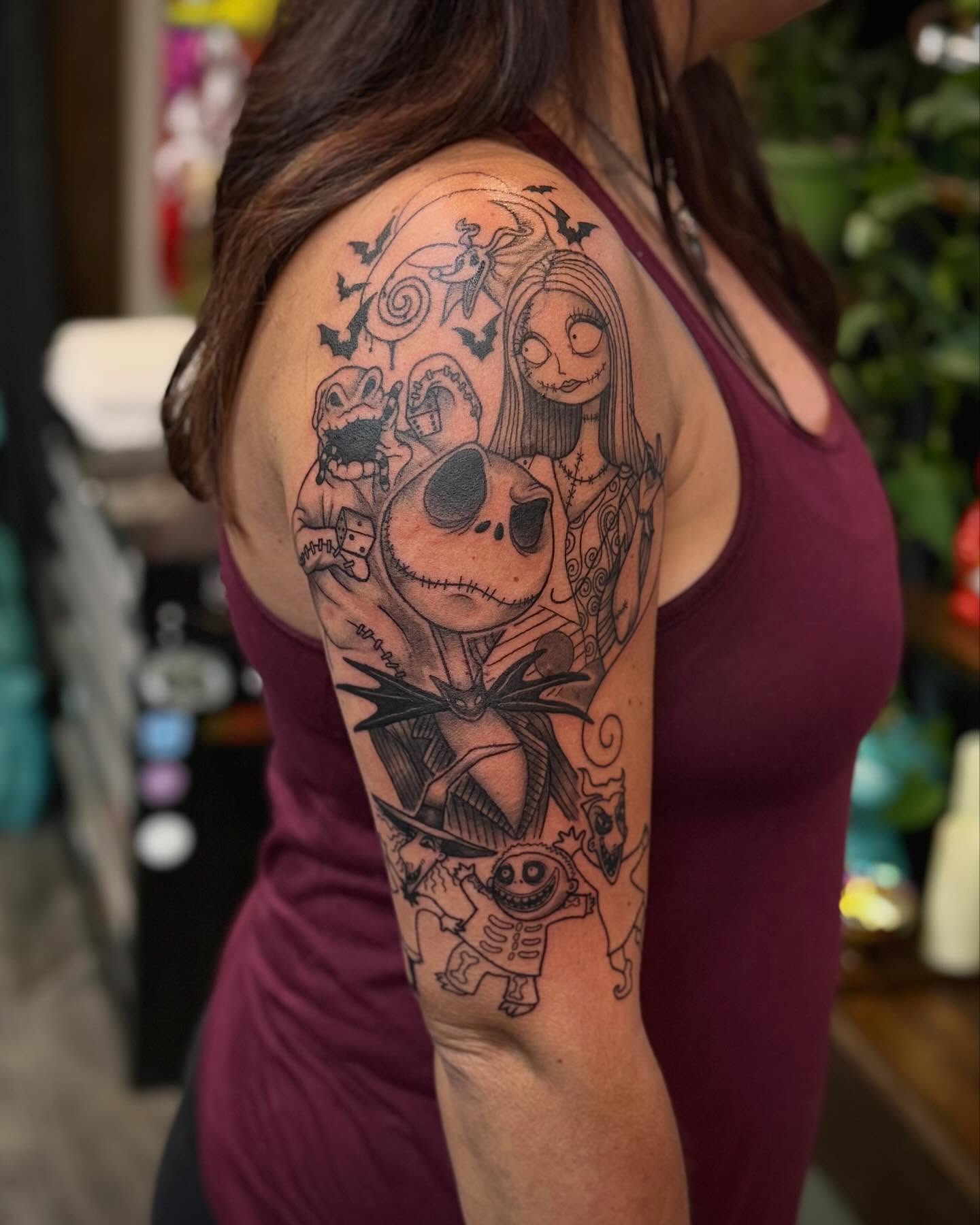 The nightmare before christmas characters realism tattoo on the upper arm by Ashley Kayser