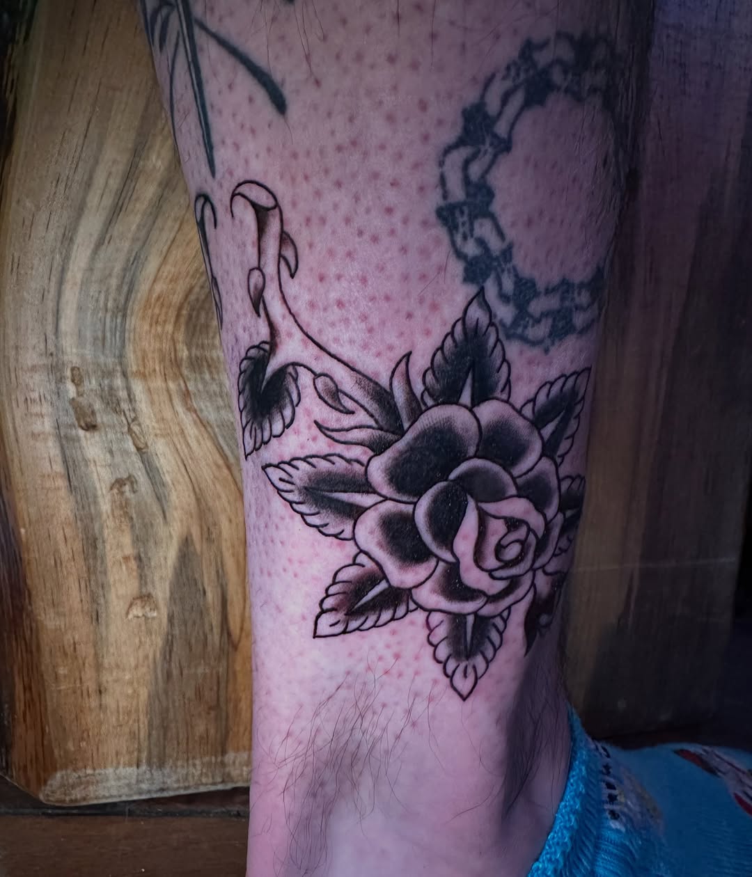 Rose and stem dotwork tattoo on the calf by Alexander Haber