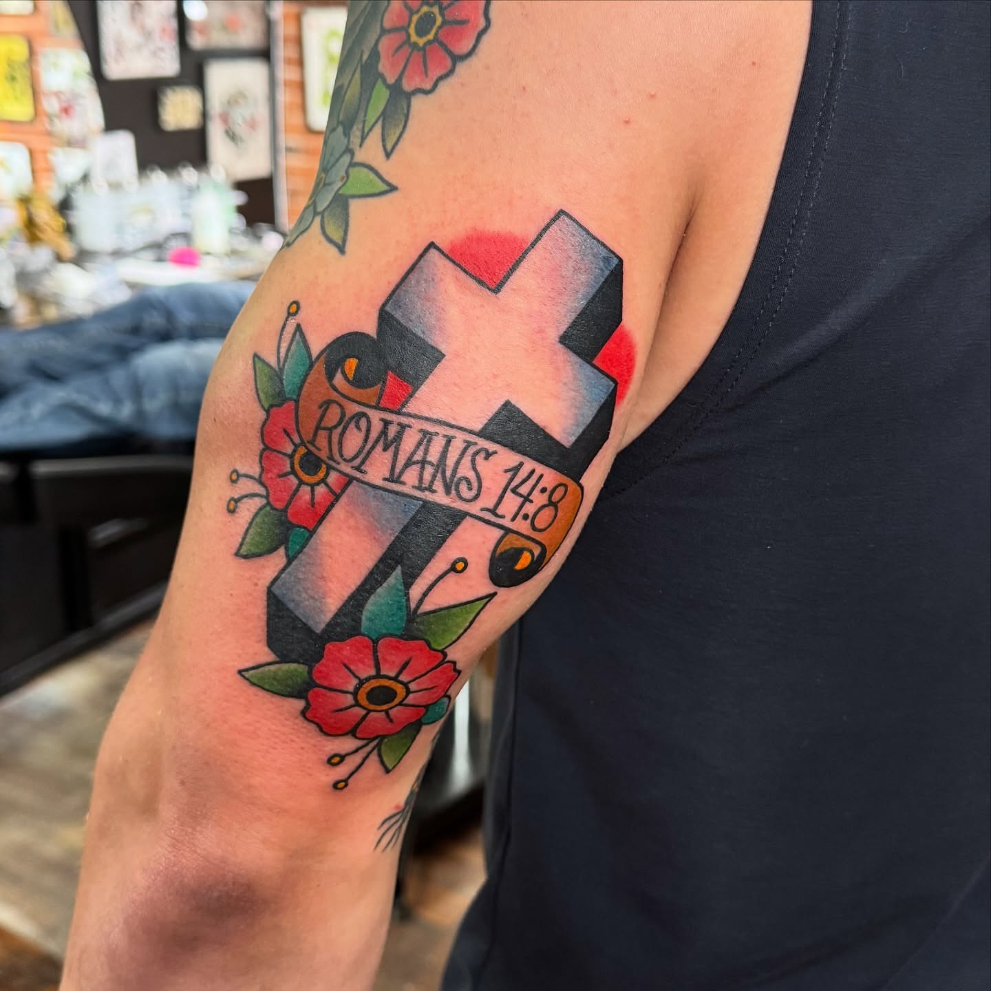 Cross with floral elements American traditional tattoo on the forearm by kenneth nash