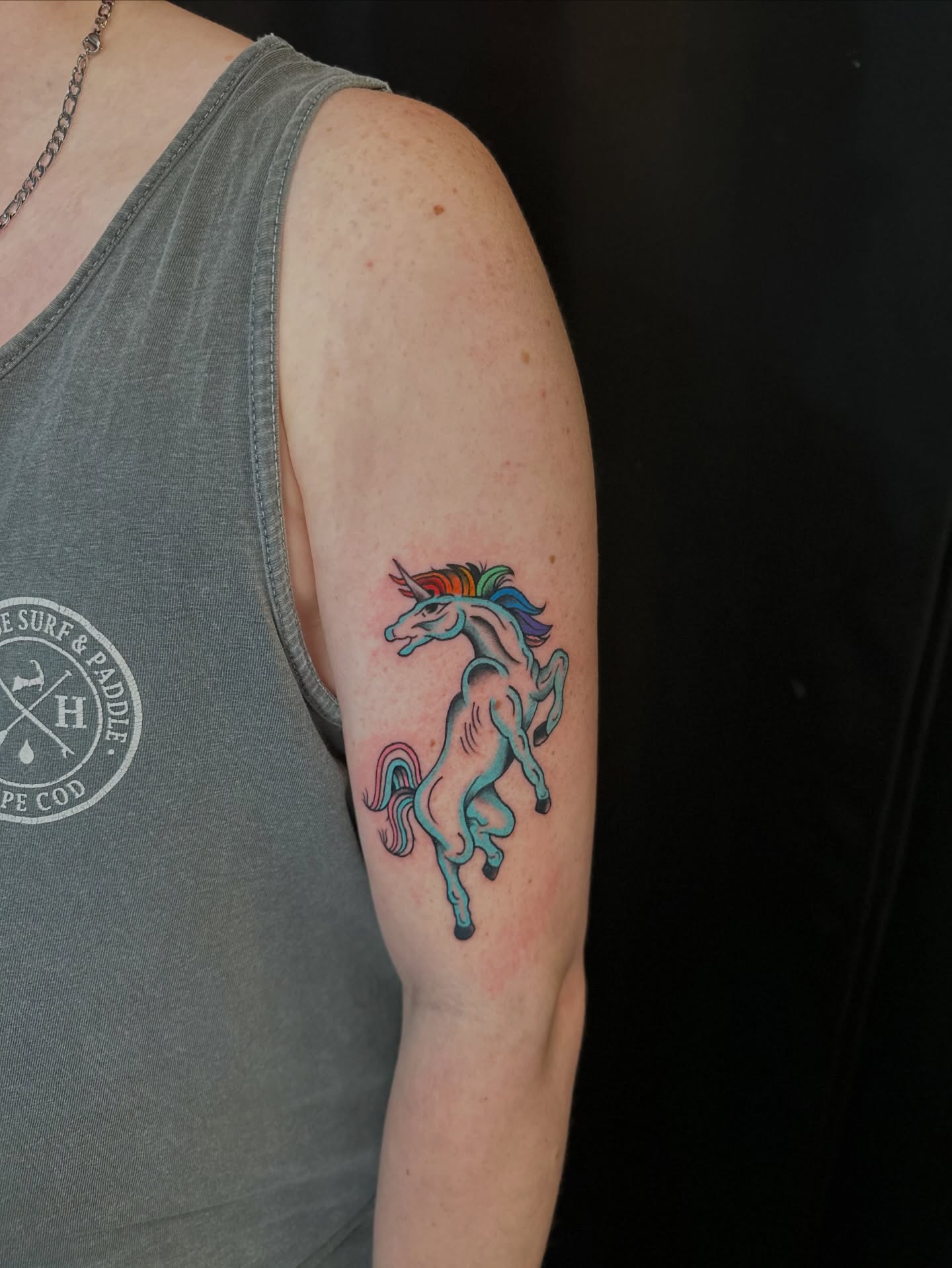 Unicorn new school tattoo on the upper arm by Tyyler Santor (Tattoo Artist), Somerville, Massachusetts