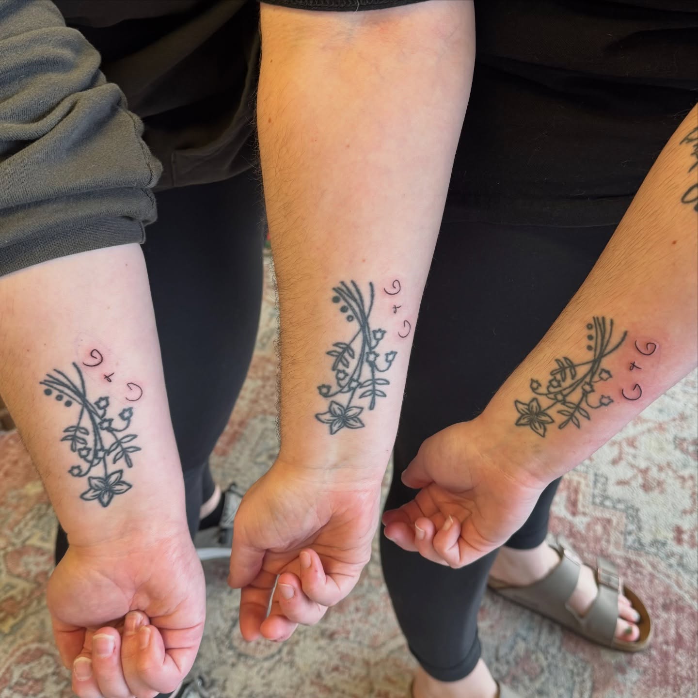 Floral arrangement black and grey tattoo on the forearm by Kat Bennett