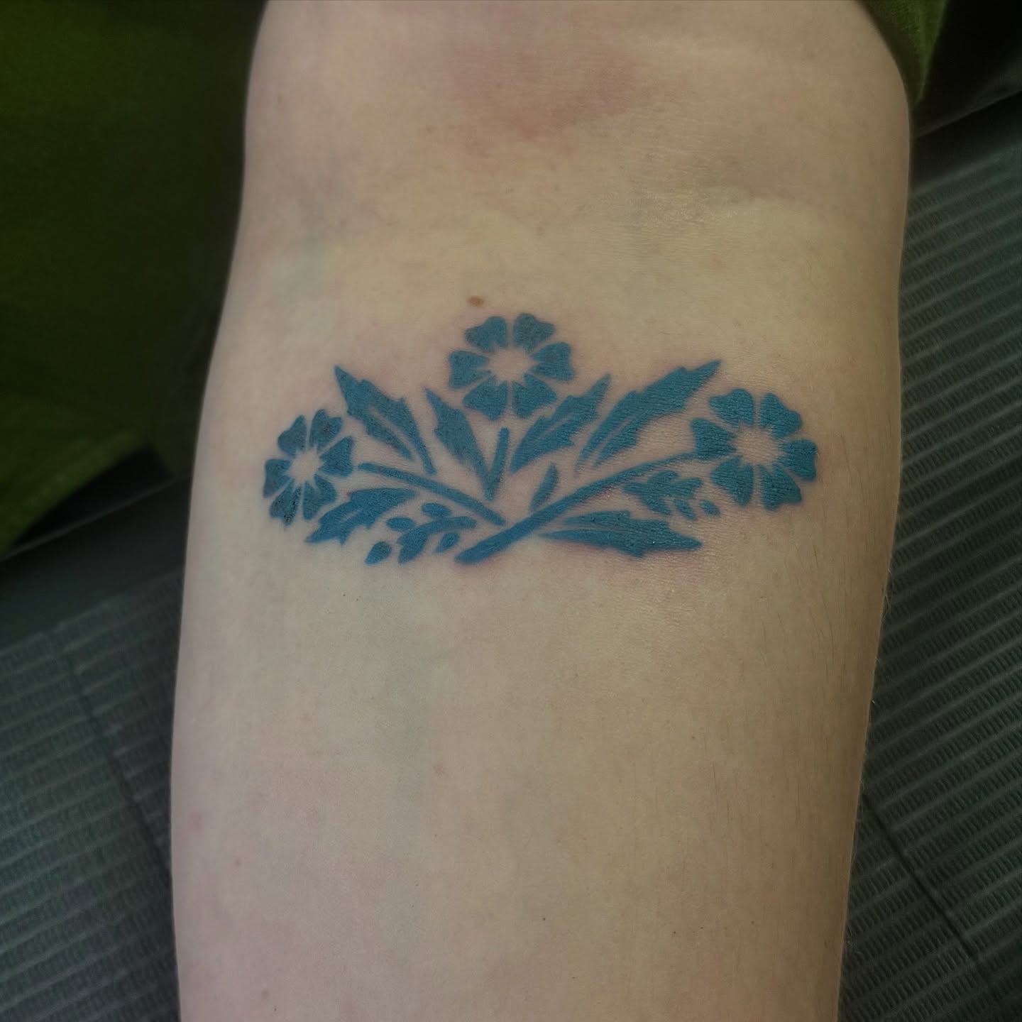 Floral arrangement ornamental tattoo on the forearm by Kat Bennett