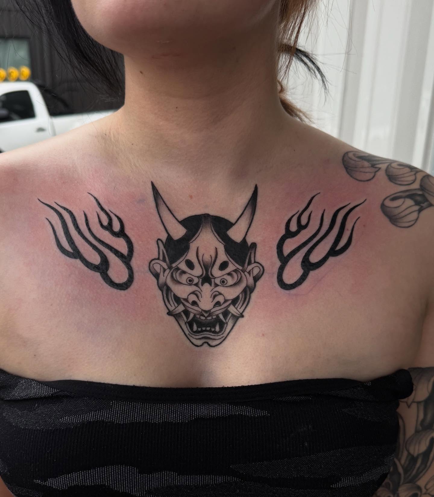 Demon mask with flames japanese irezumi tattoo on the chest by frankie quadrini