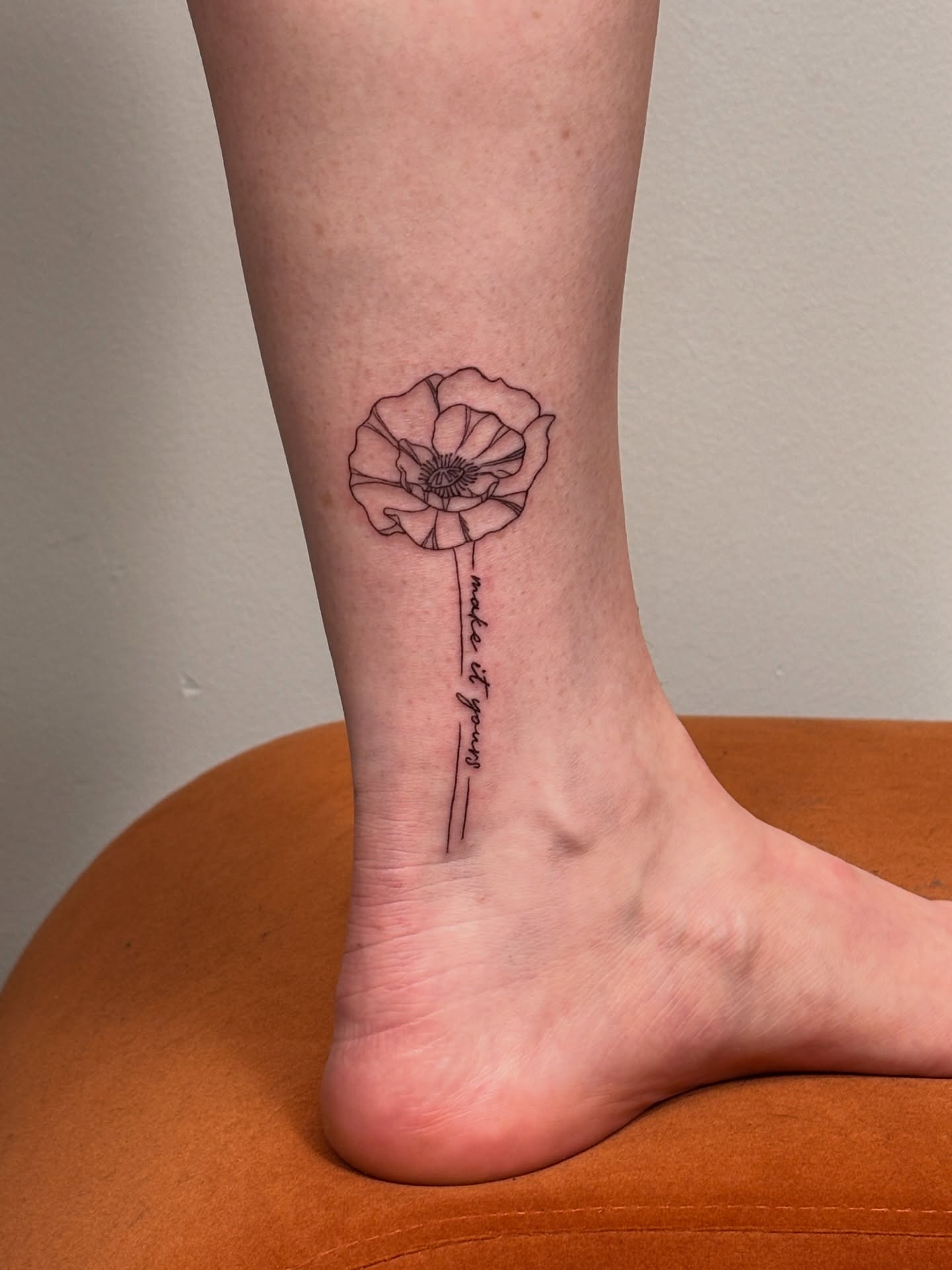 Poppy flower fine line tattoo on the foot by Maddie