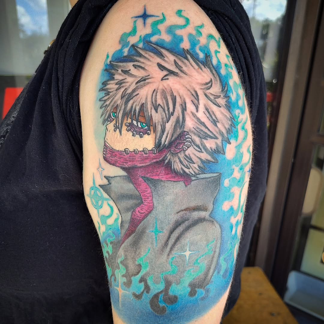 Anime character anime tattoo on the upper arm by Julie MacDonald