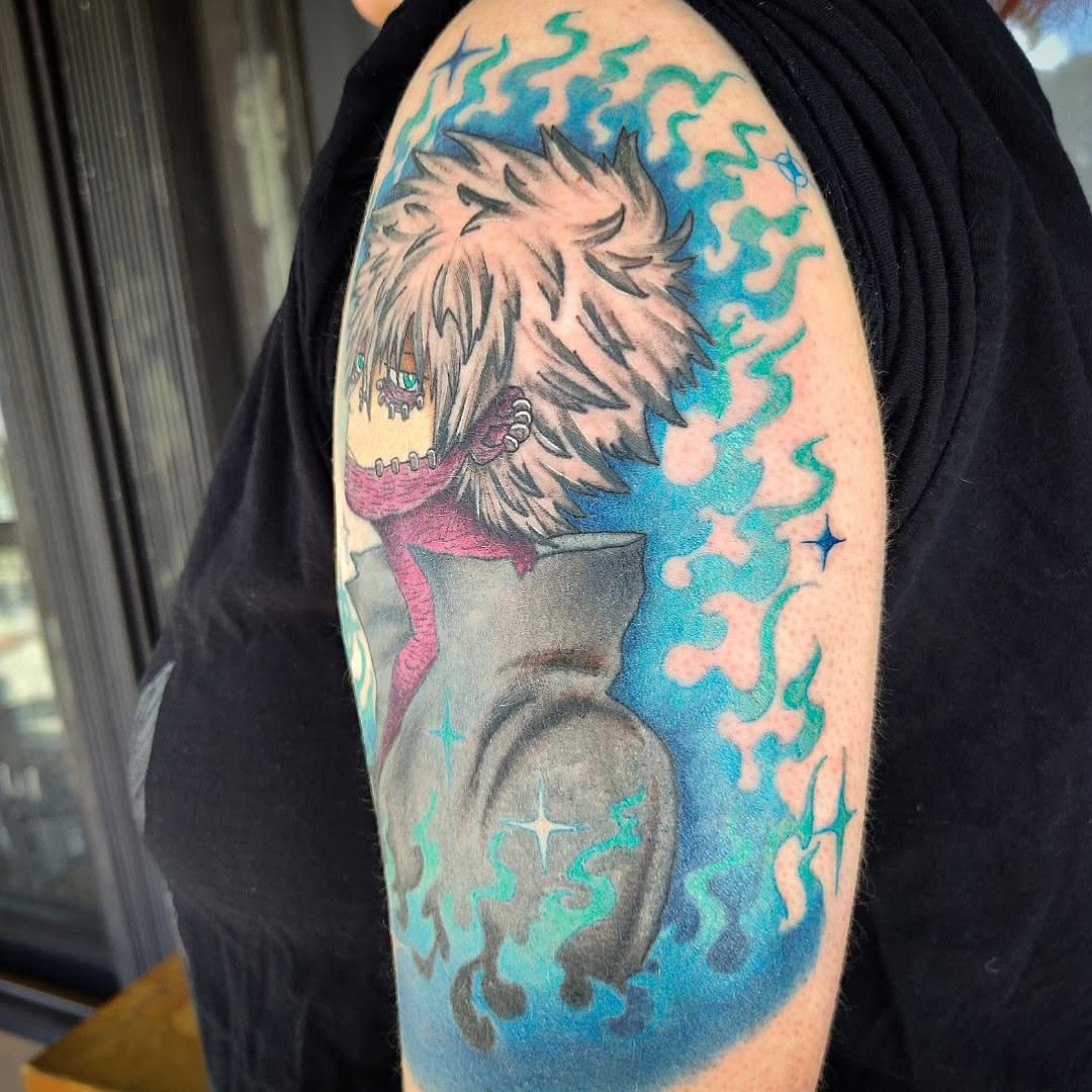 Anime character anime tattoo on the upper arm by Julie MacDonald
