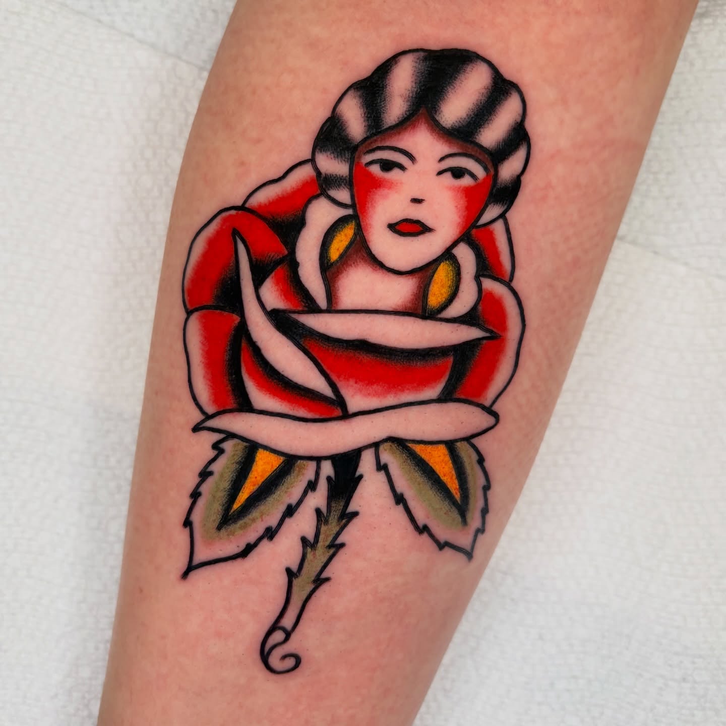 Woman in rose American traditional tattoo on the forearm by rachael