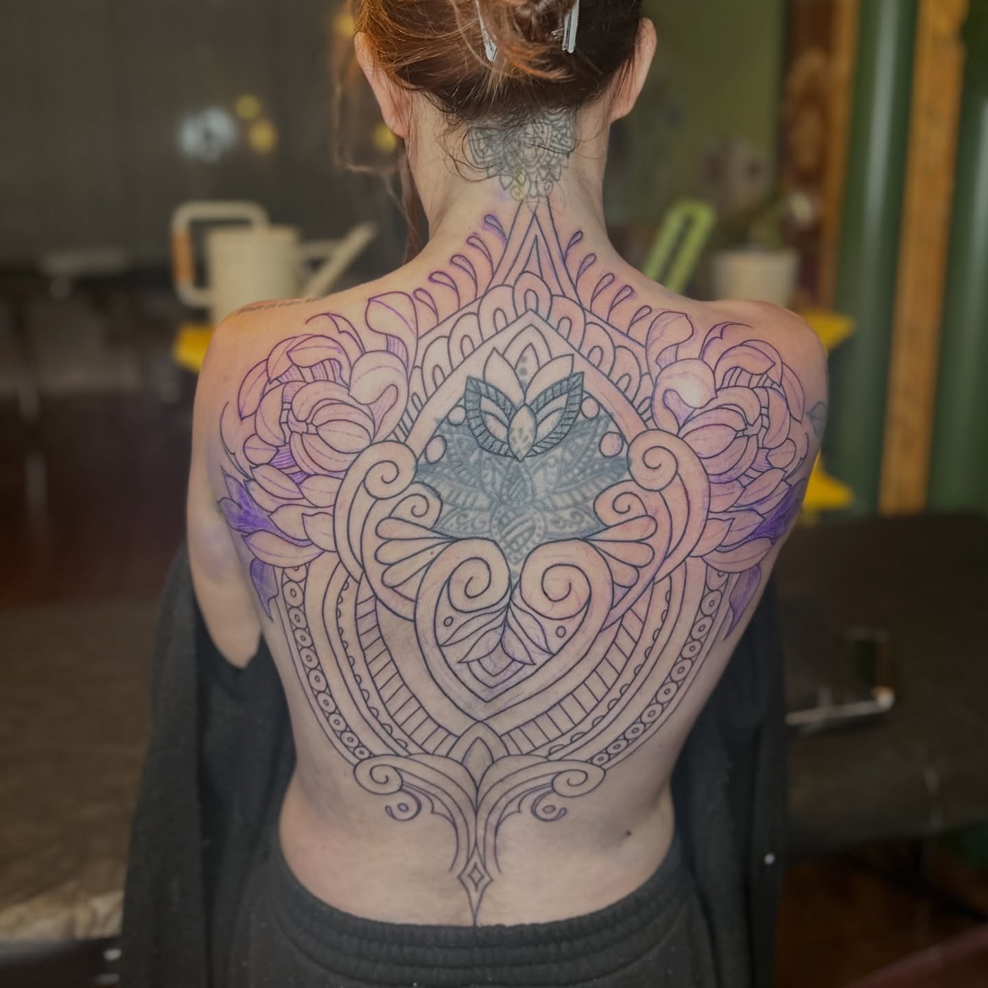 Heart with floral mandala ornamental tattoo on the back by Brieana Smith