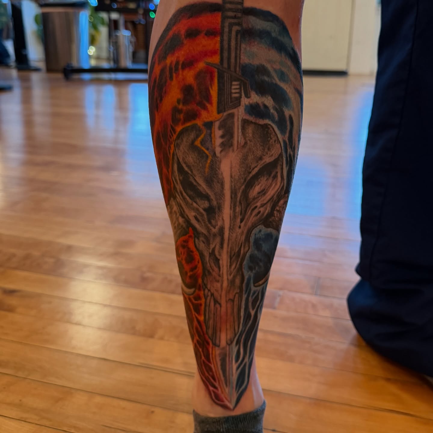 Skull and gun dark realism tattoo on the calf by steven
