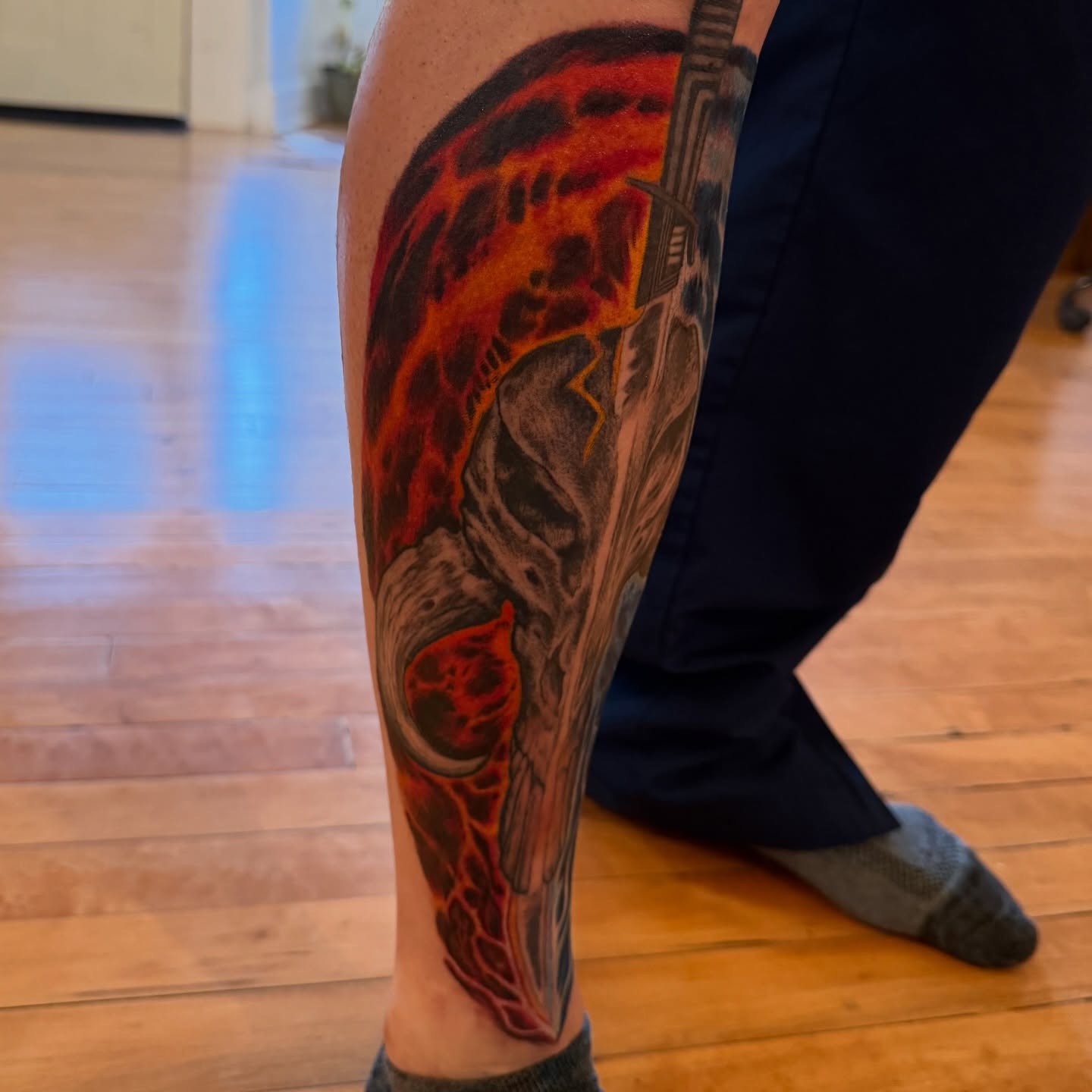 Fire and skull dark realism tattoo on the calf by steven