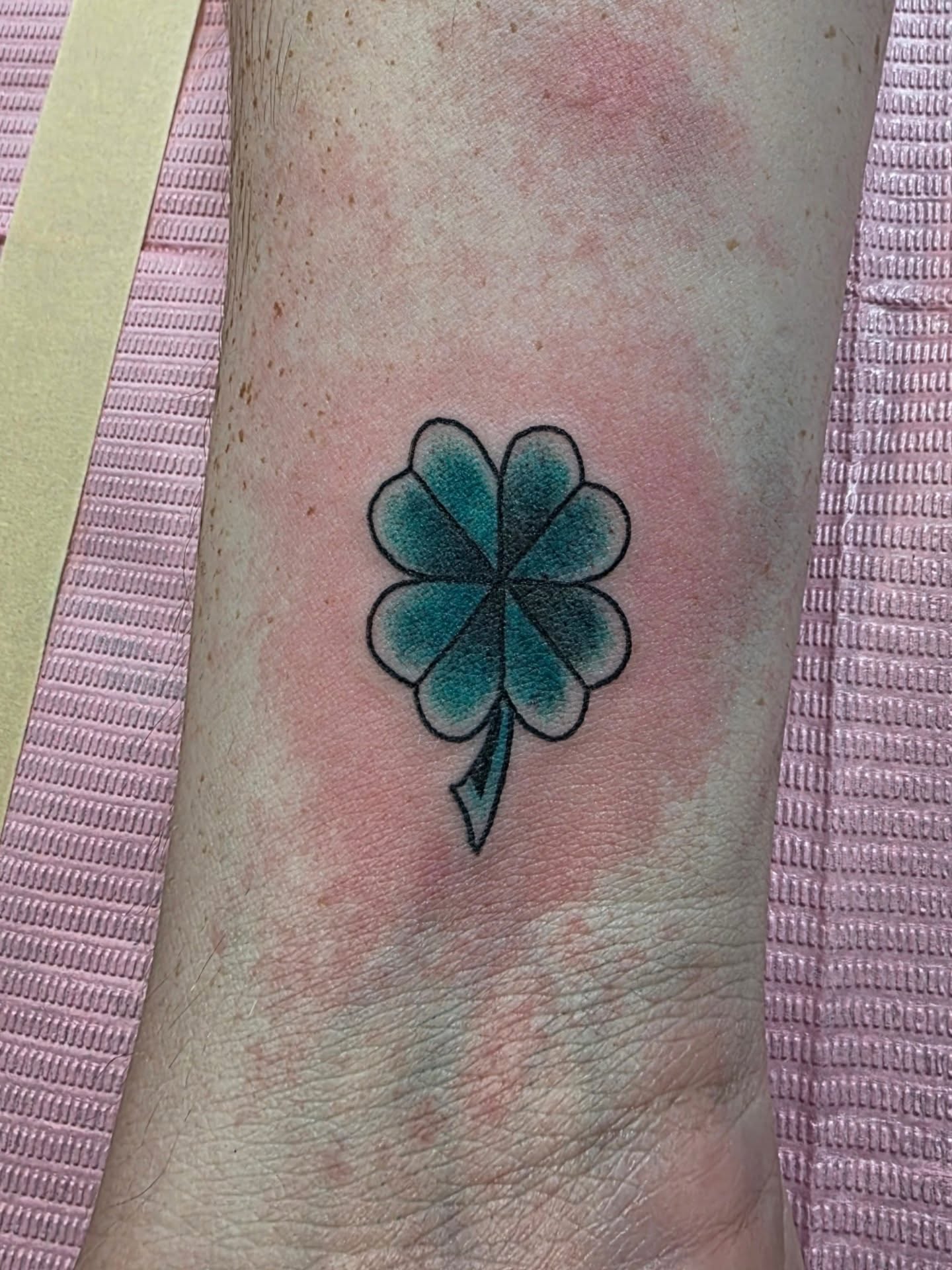 Four-leaf clover geometric tattoo on the forearm by Tattoos by Annie
