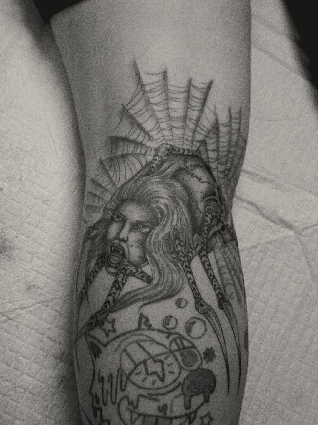 Spider woman and cartoon character blackwork tattoo on the forearm by Matthew Ulrich