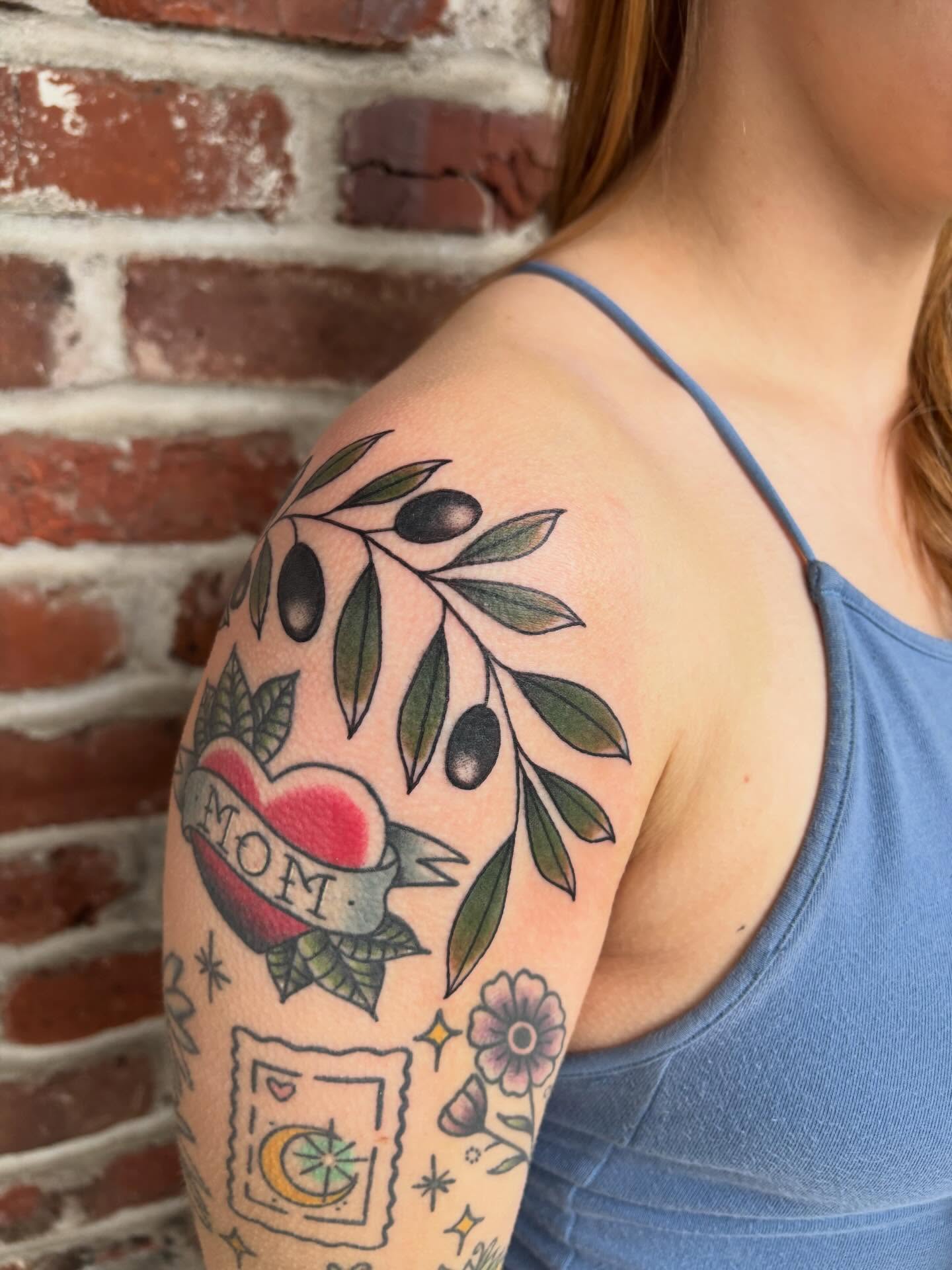 Olive branch with heart American traditional tattoo on the shoulder by Malia Clark