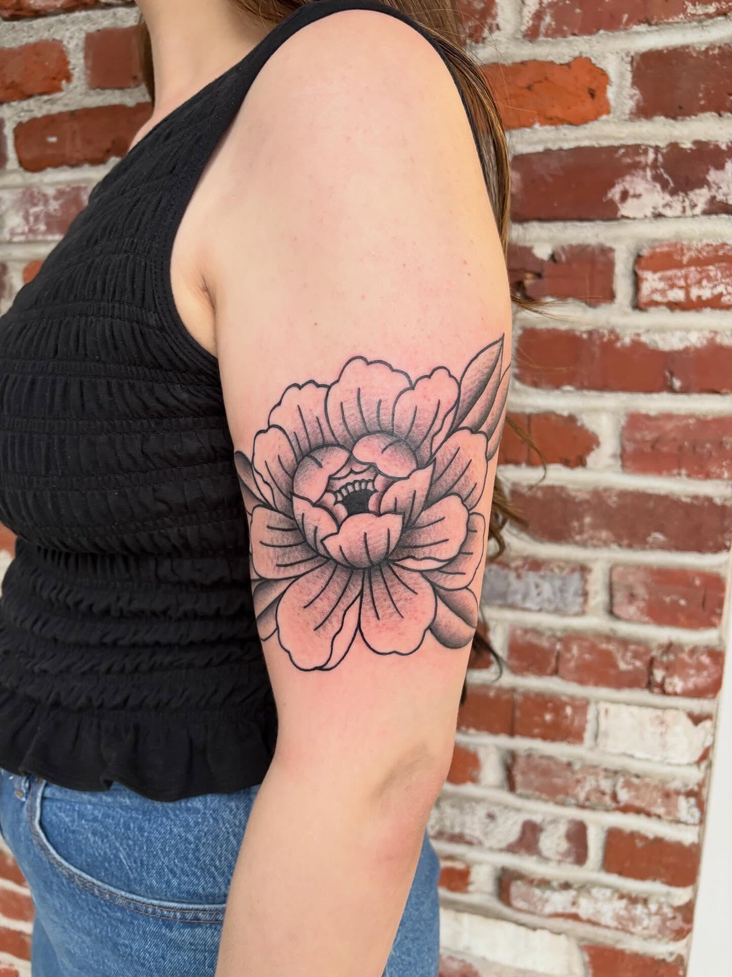 Peony black and grey tattoo on the forearm by Malia Clark